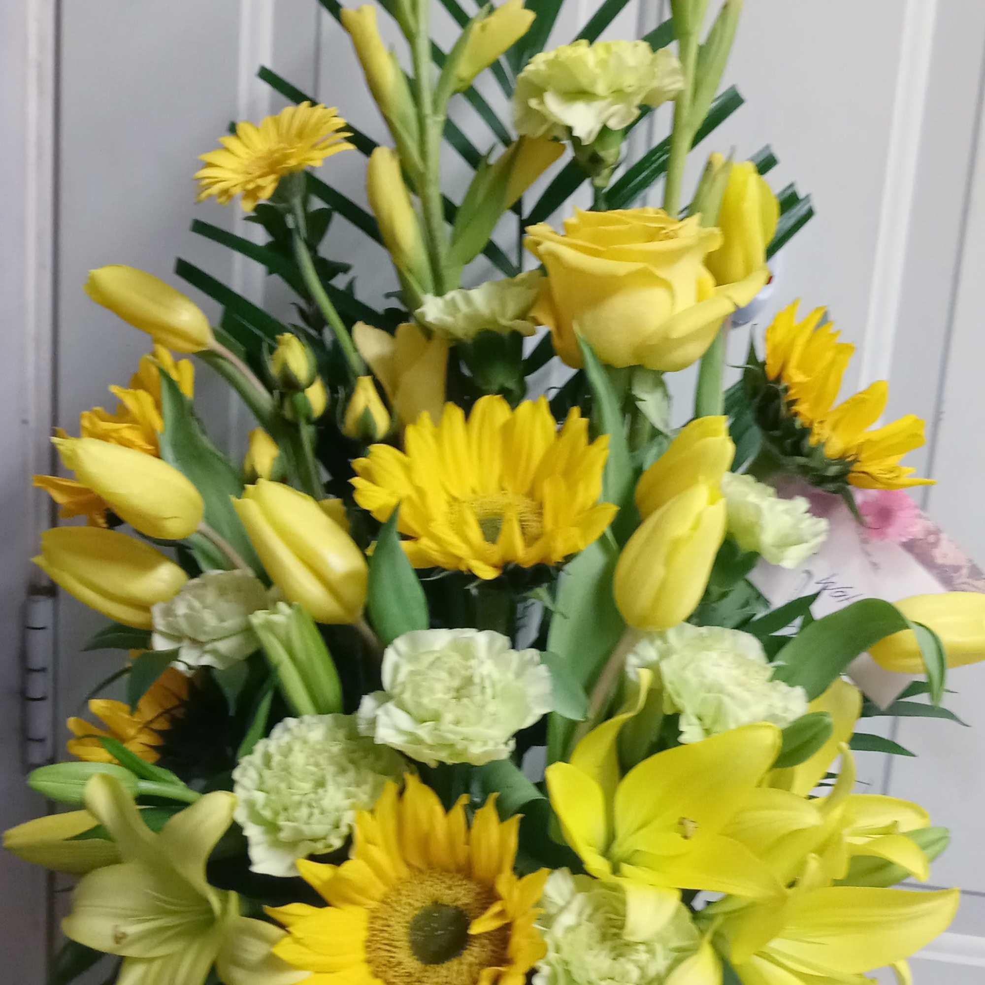 Yellow bouquet with roses, lilies, sunflowers, and carnations