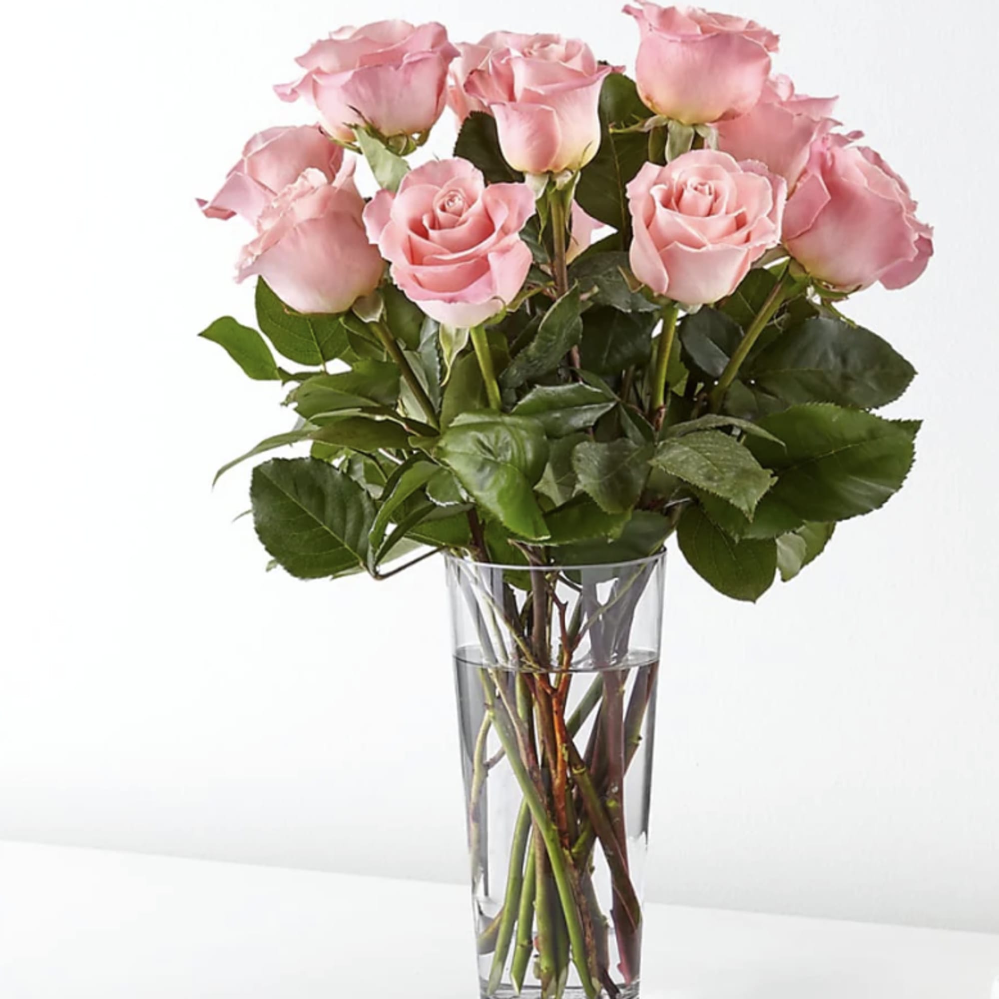 Pink roses arranged in a clear glass vase