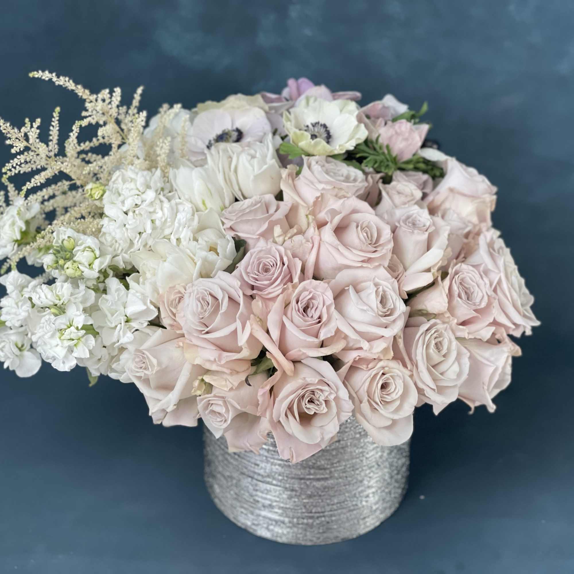 Blush and white rose bouquet in a silver textured vase