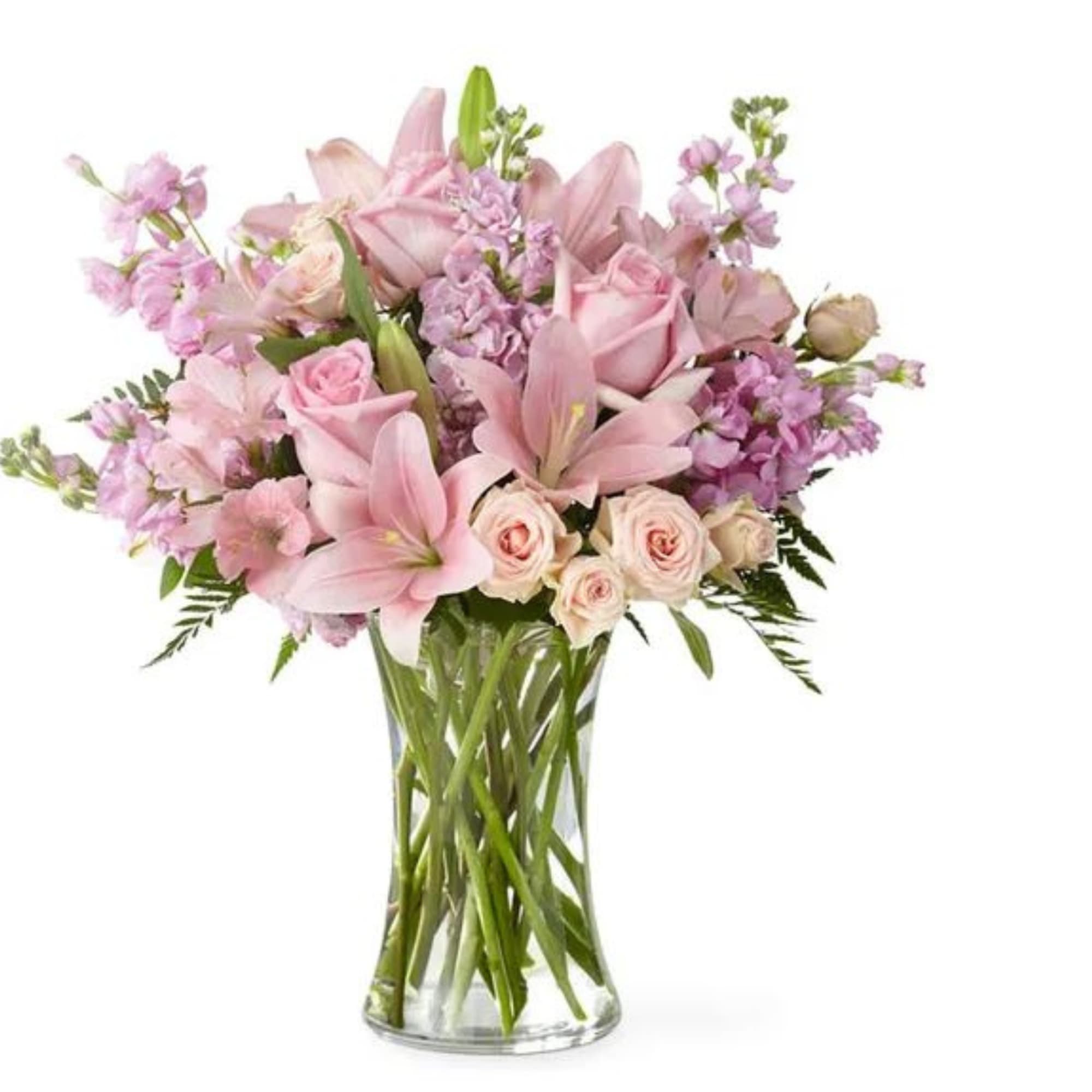 Pink lilies and roses arranged in a clear glass vase