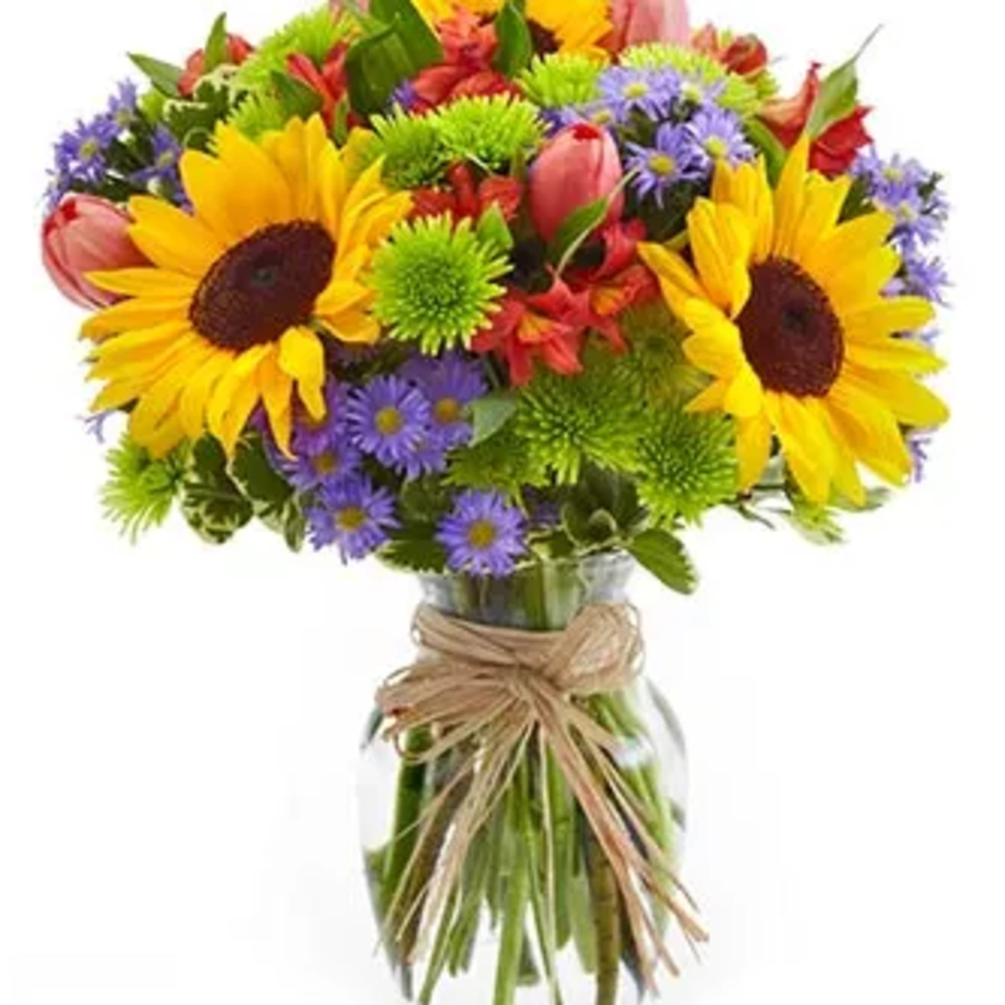 Colorful bouquet of sunflowers, tulips, and purple daisies in a glass vase