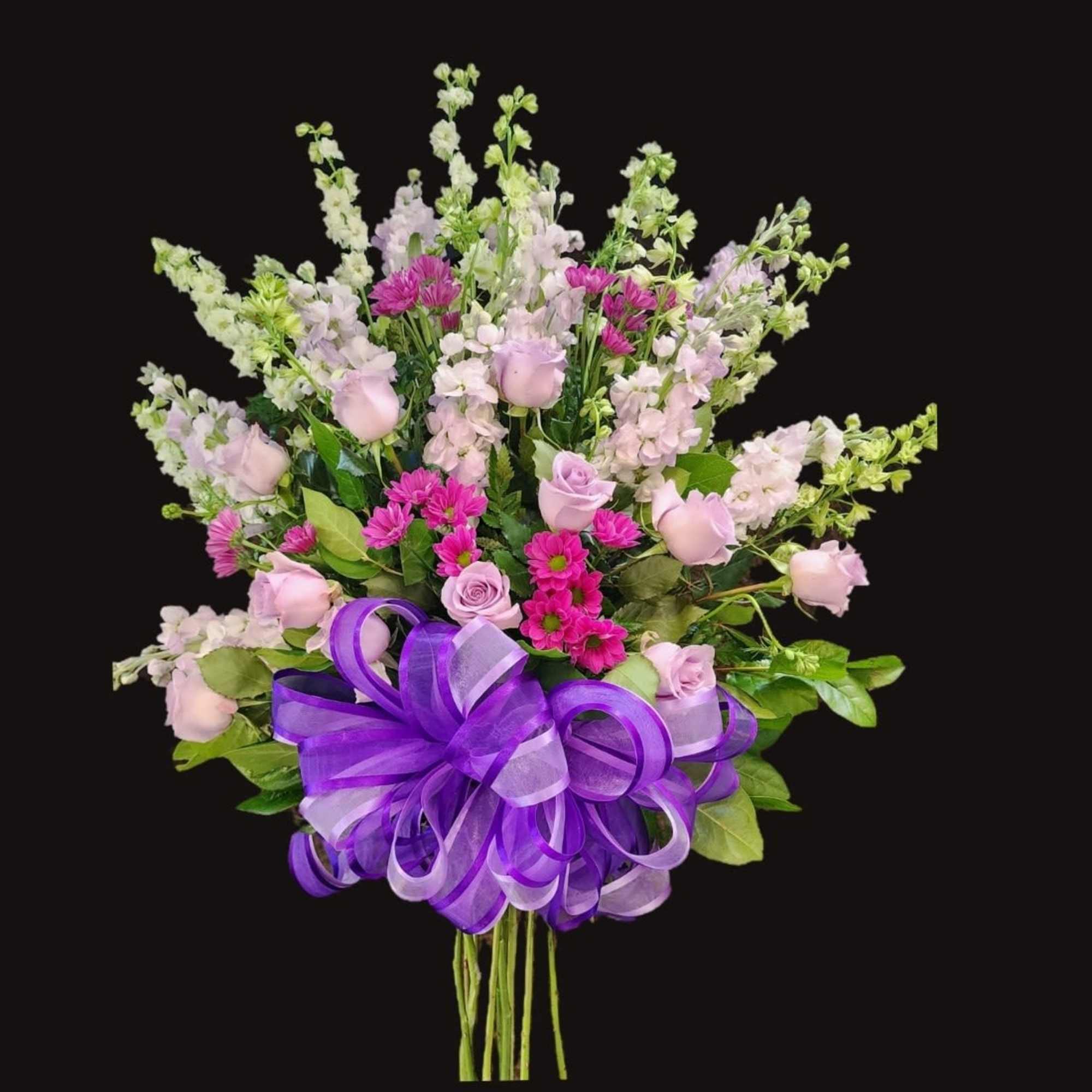 Bouquet of pink and lavender flowers with a purple ribbon bow