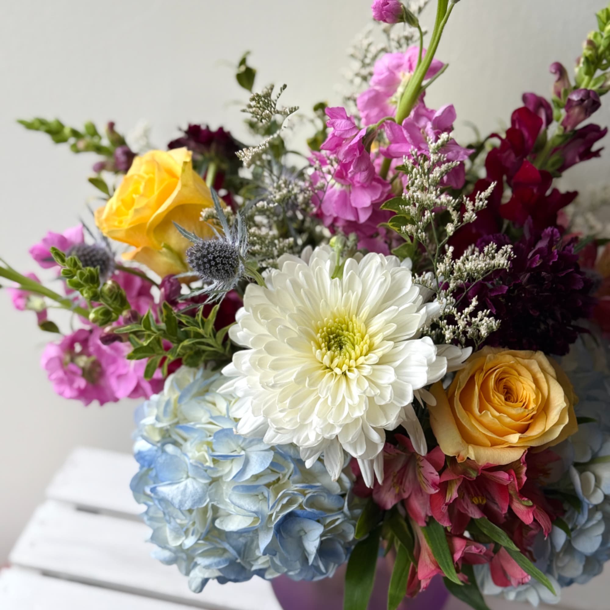 Mixed bouquet with white chrysanthemum, yellow roses, and blue hydrangea