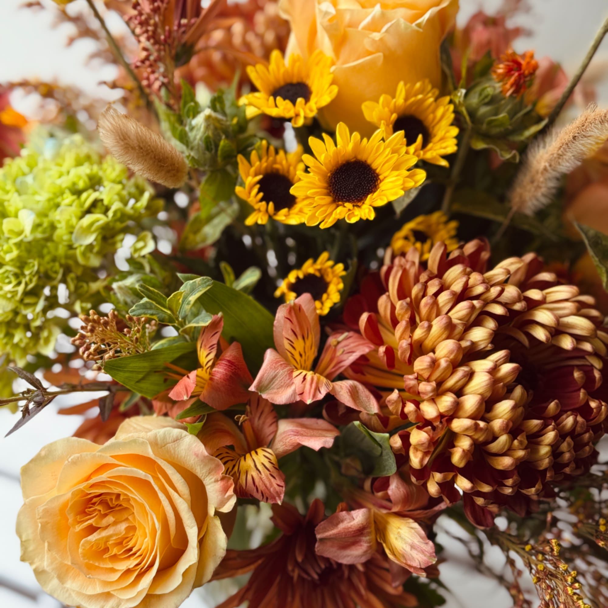 Bouquet with yellow sunflowers, peach roses, and burgundy chrysanthemums