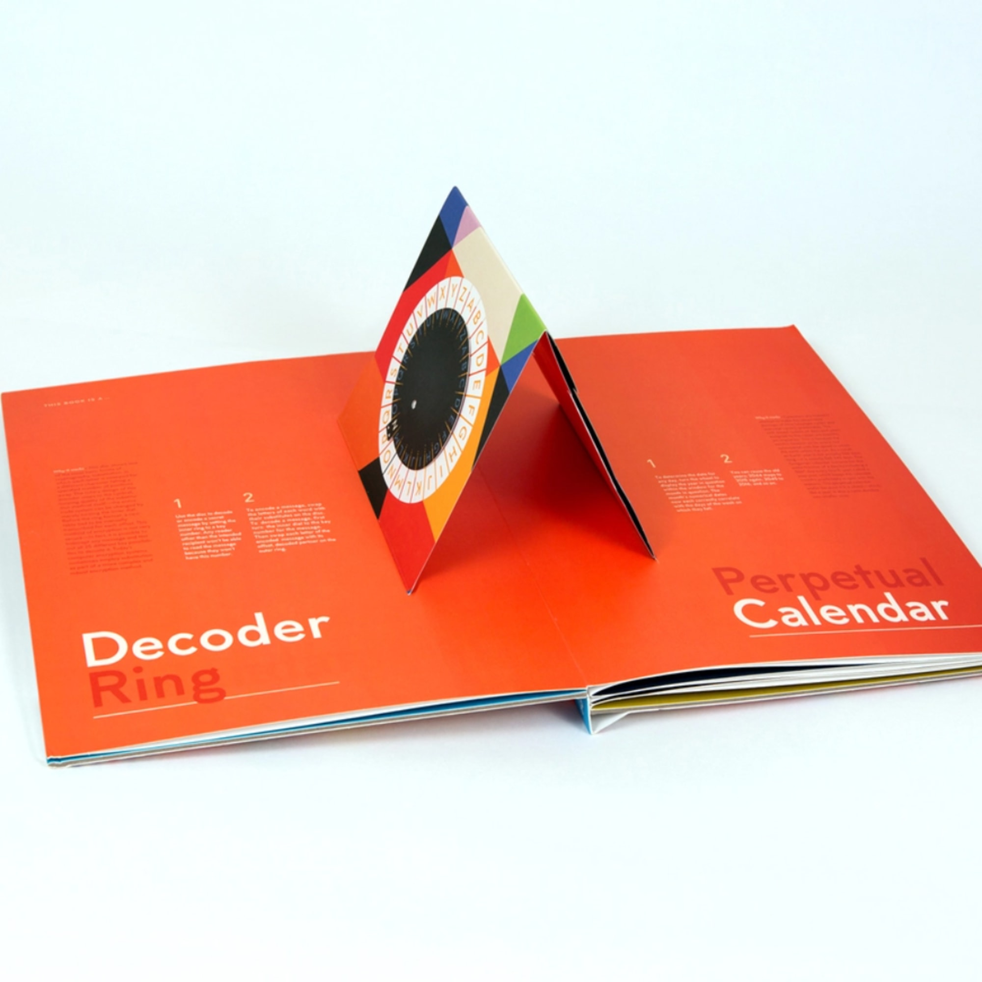 Open orange perpetual calendar with a colorful triangular ring insert