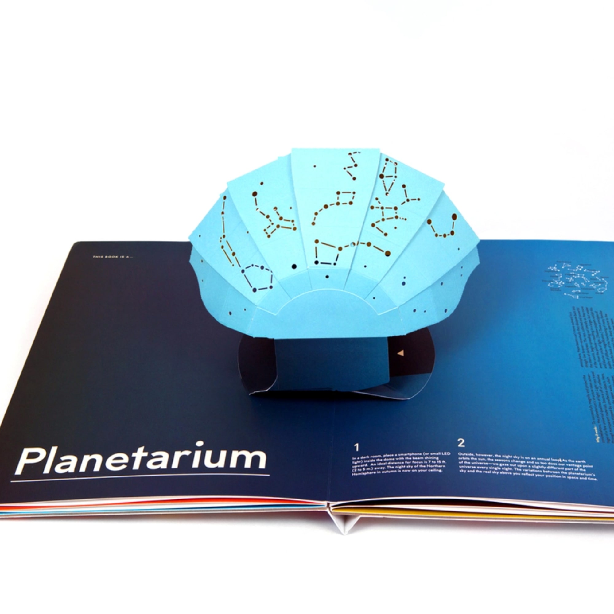 Pop-up book with a blue constellation dome labeled Planetarium