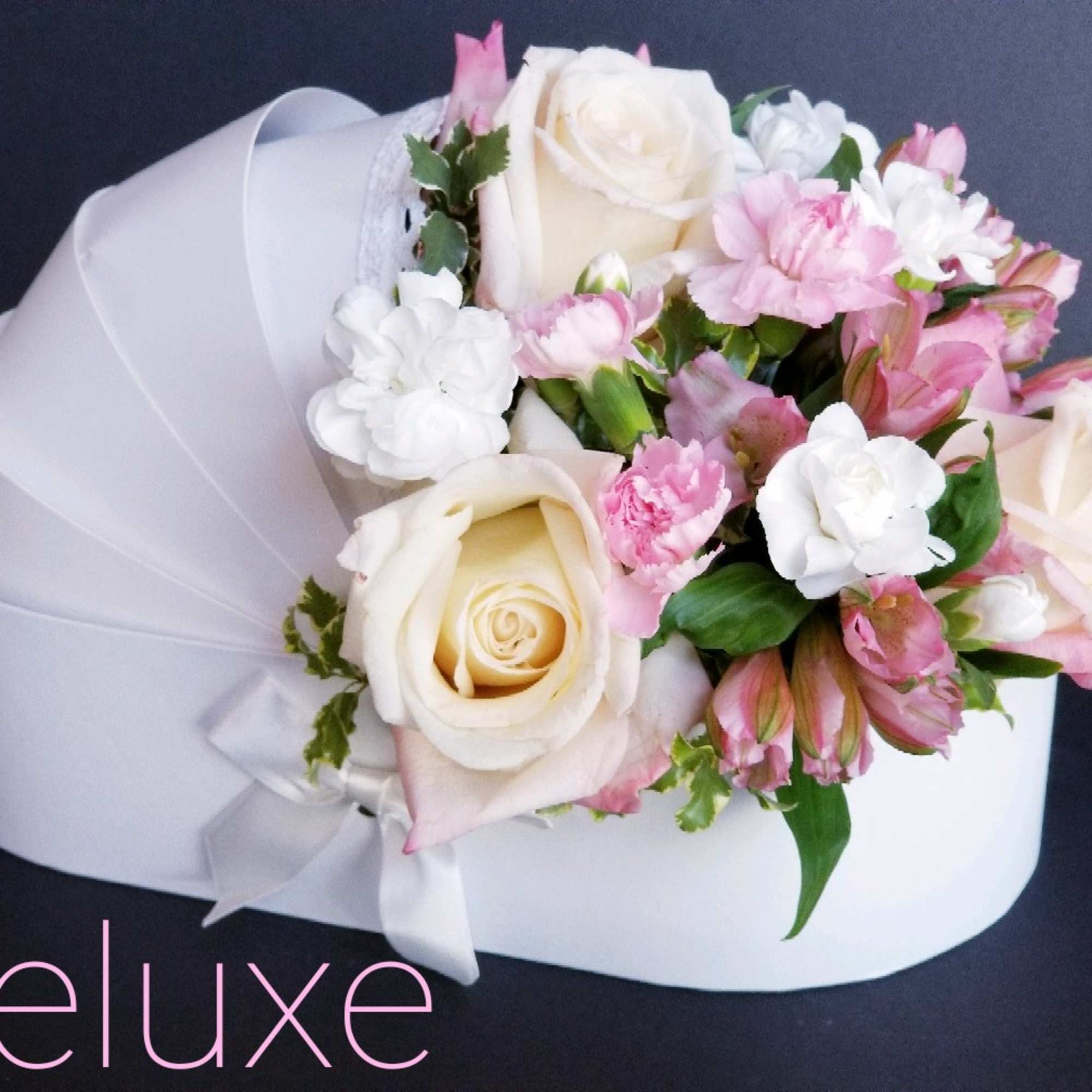 Pink and white rose bouquet with carnations wrapped in white paper