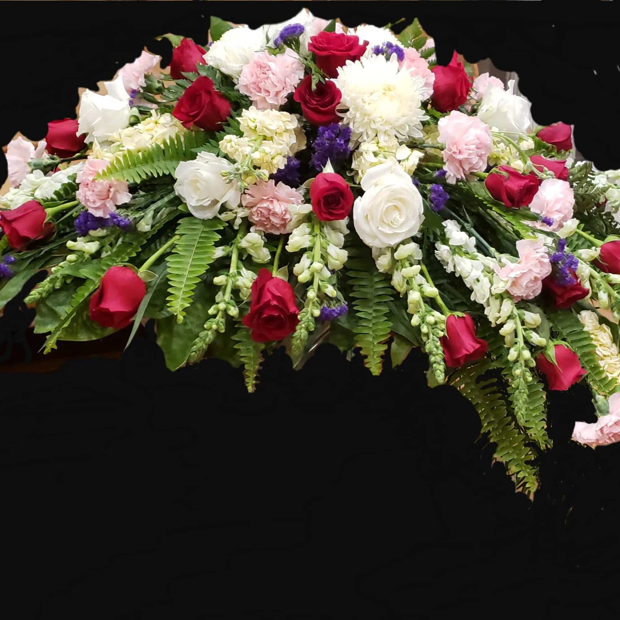 Casket spray with red and white roses, pink carnations, and greenery