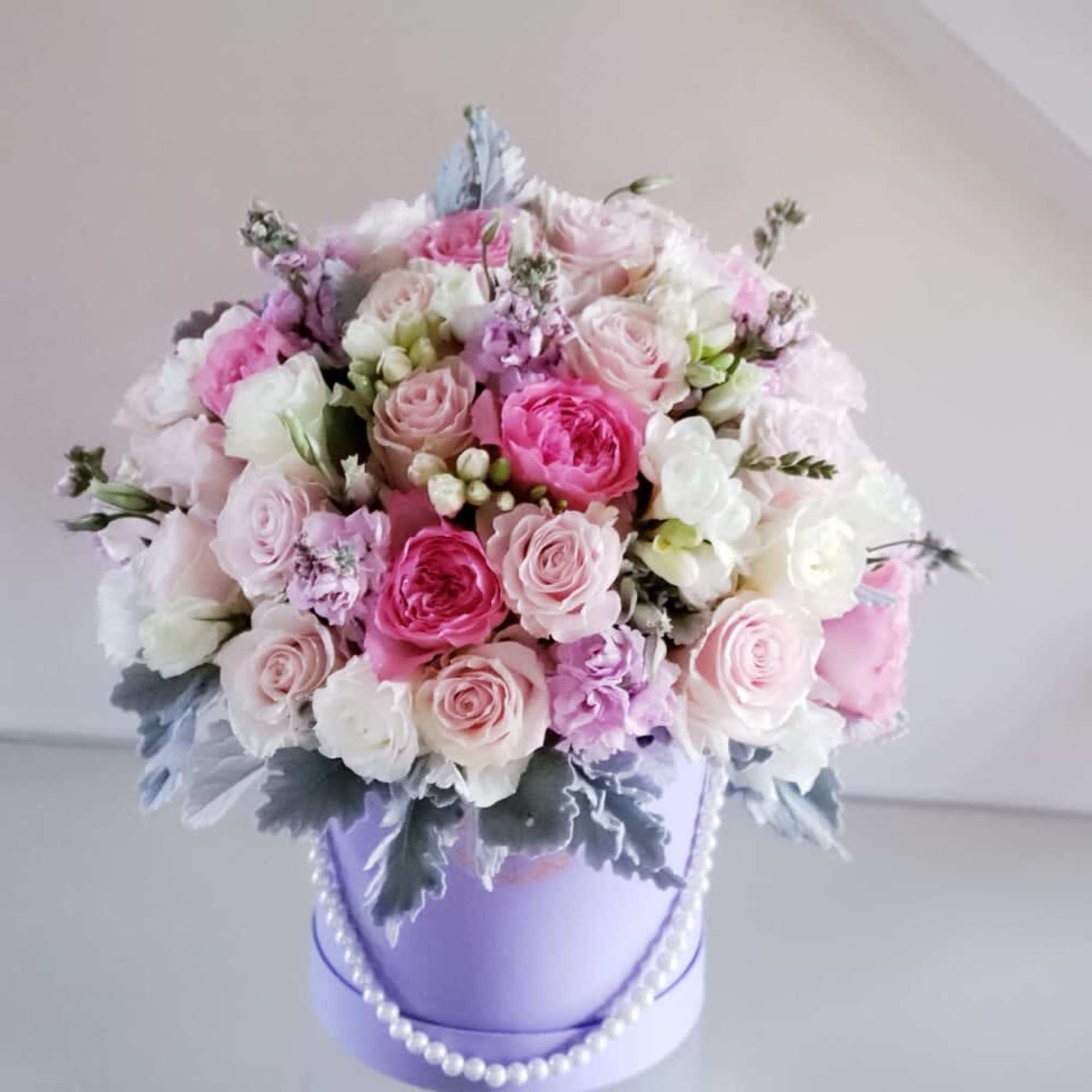 Pink and white rose bouquet in a lavender hatbox with pearl trim
