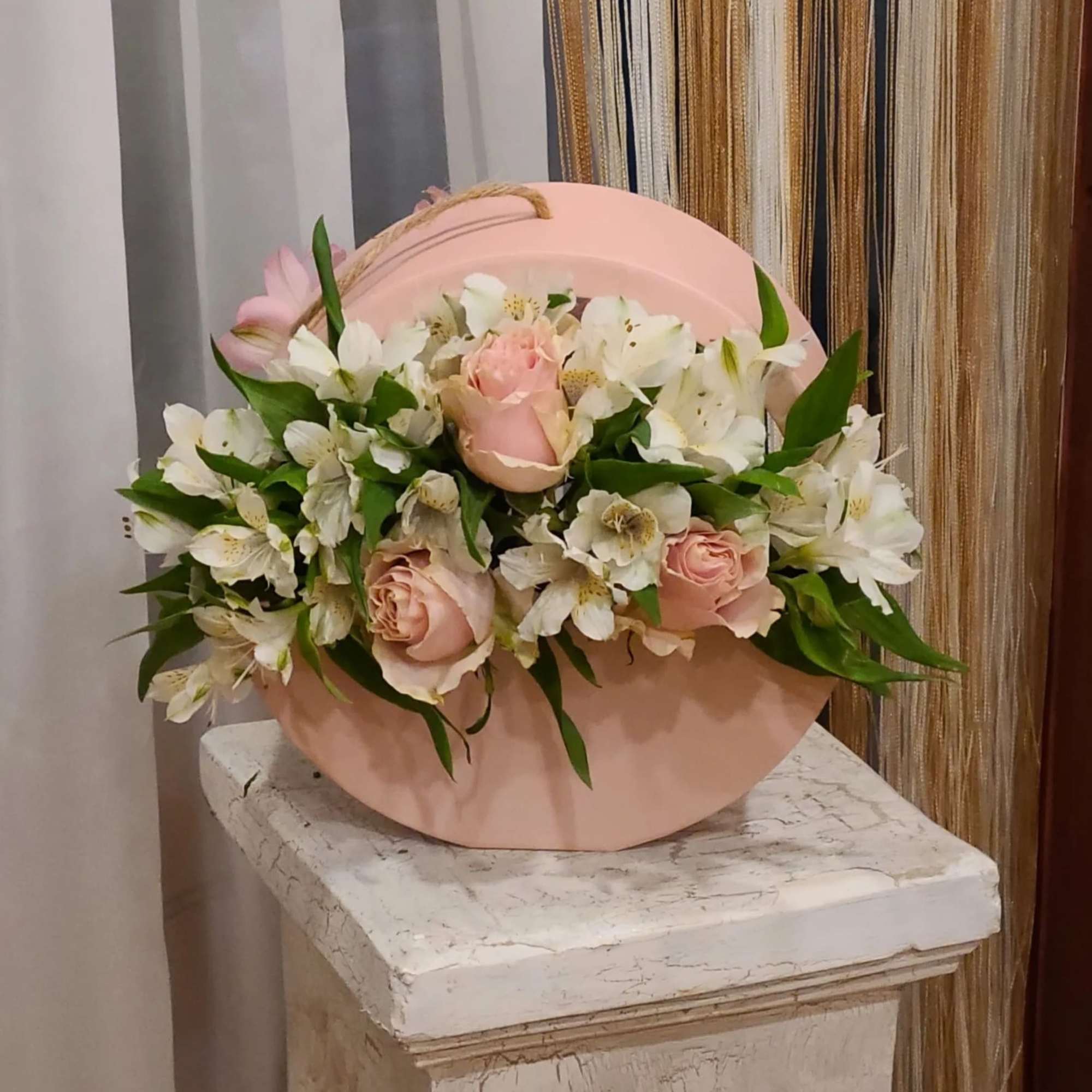 Pink hatbox arrangement with pale roses and white flowers