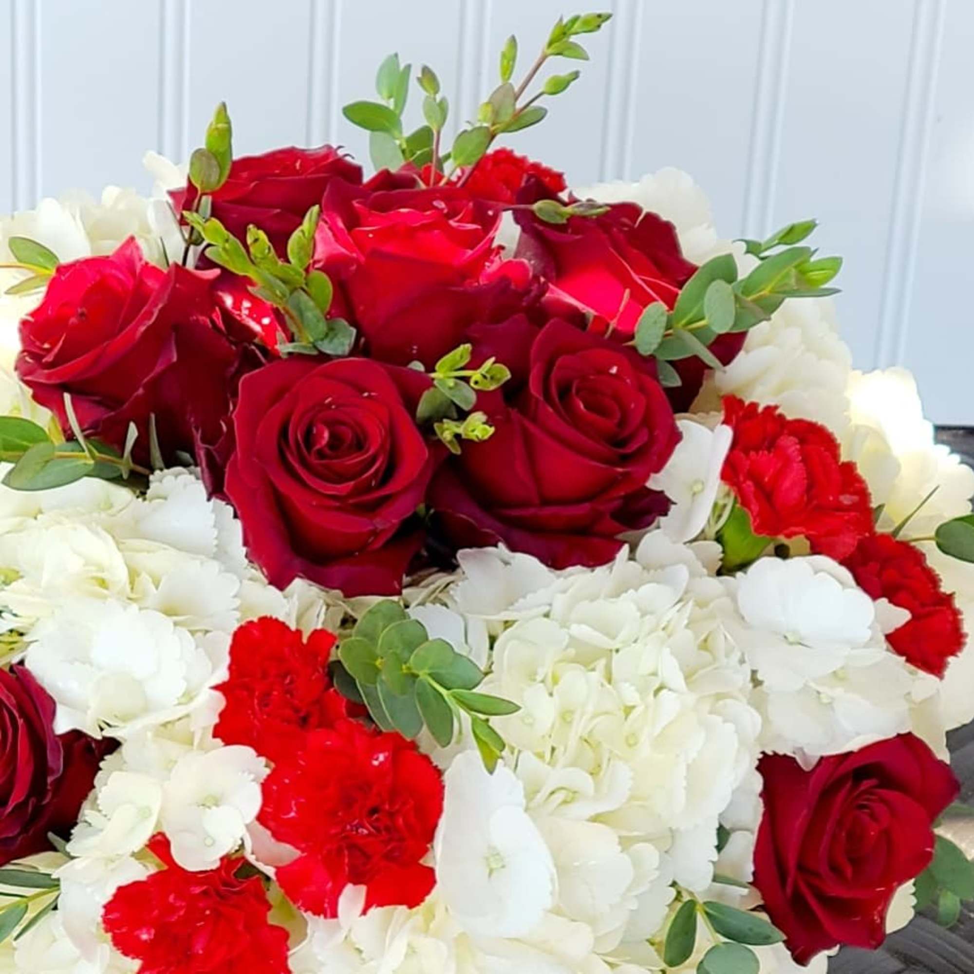 Bouquet of red roses and white hydrangeas with small red carnations