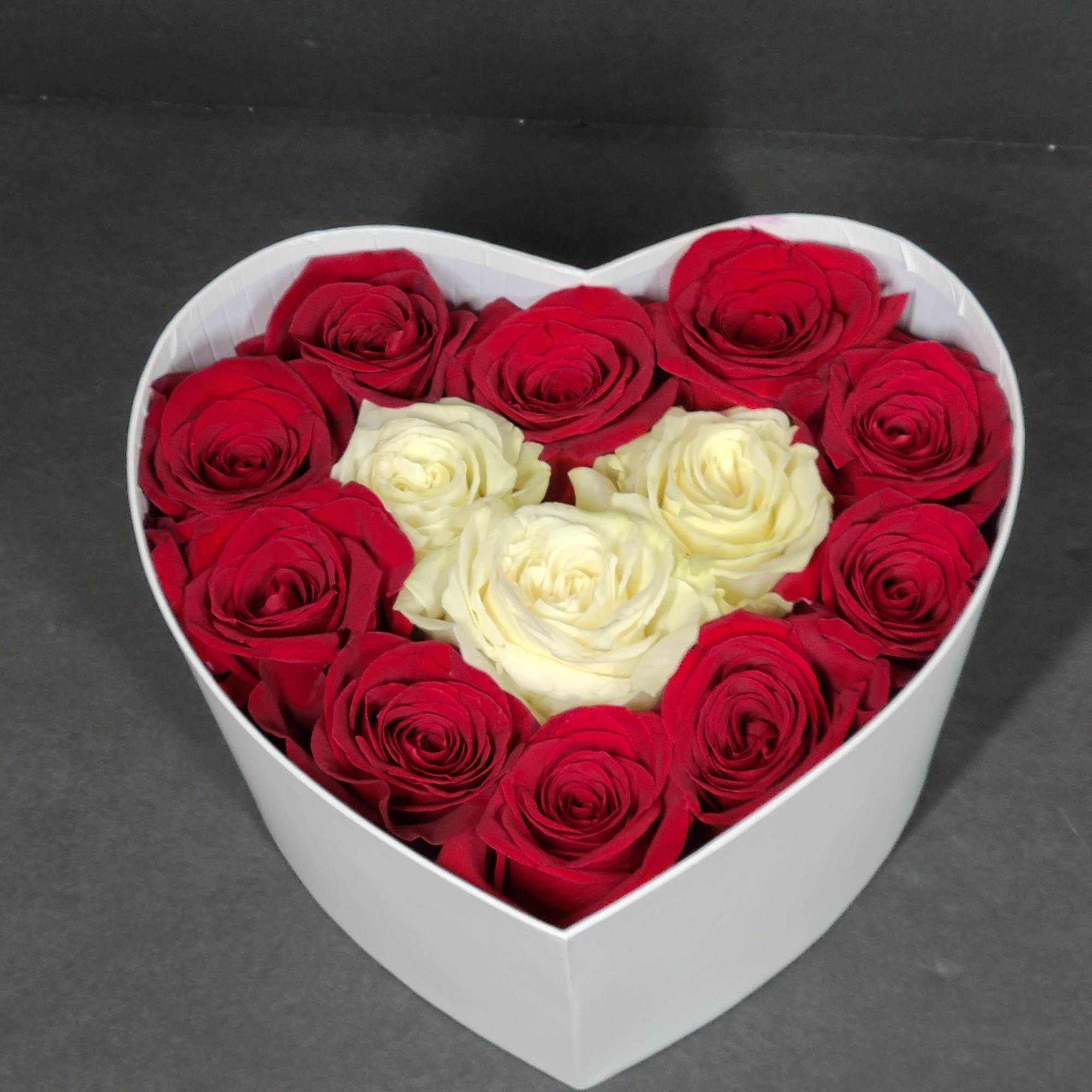 Heart-shaped box of red and white roses
