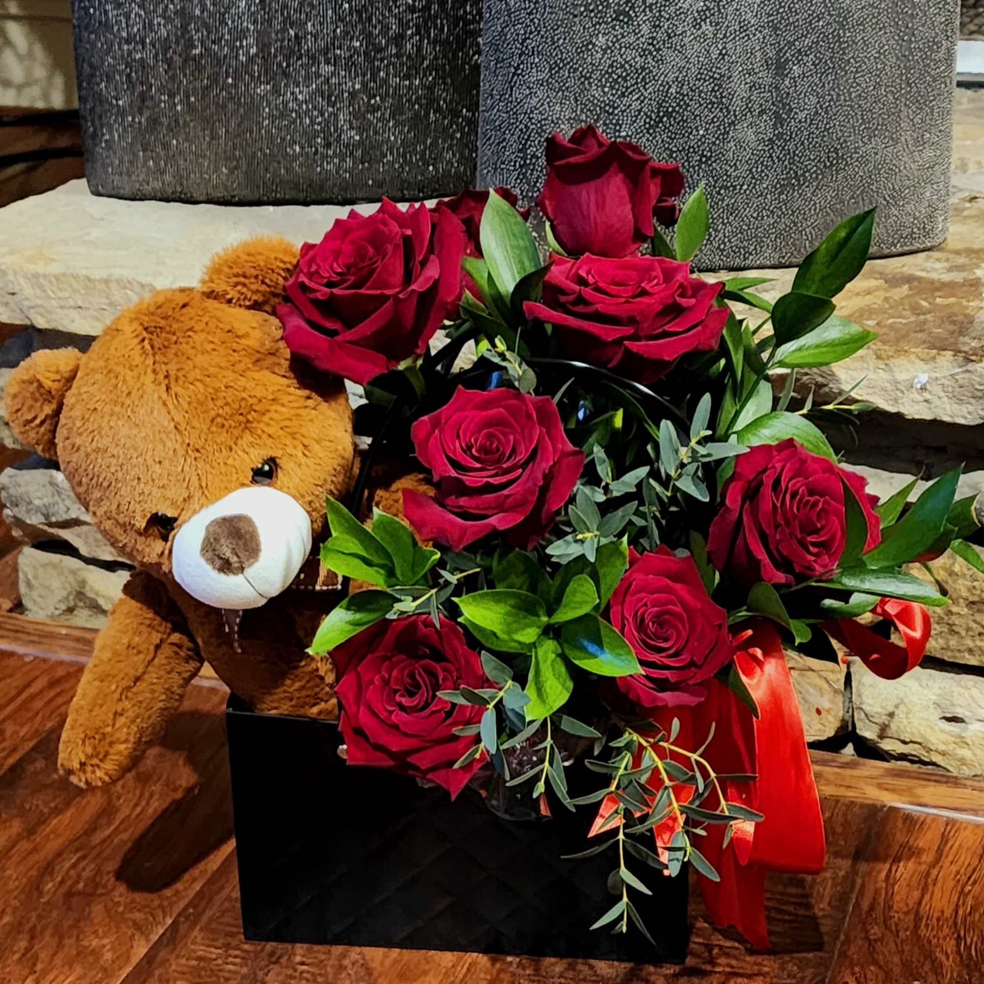 Red roses with a teddy bear in a black box