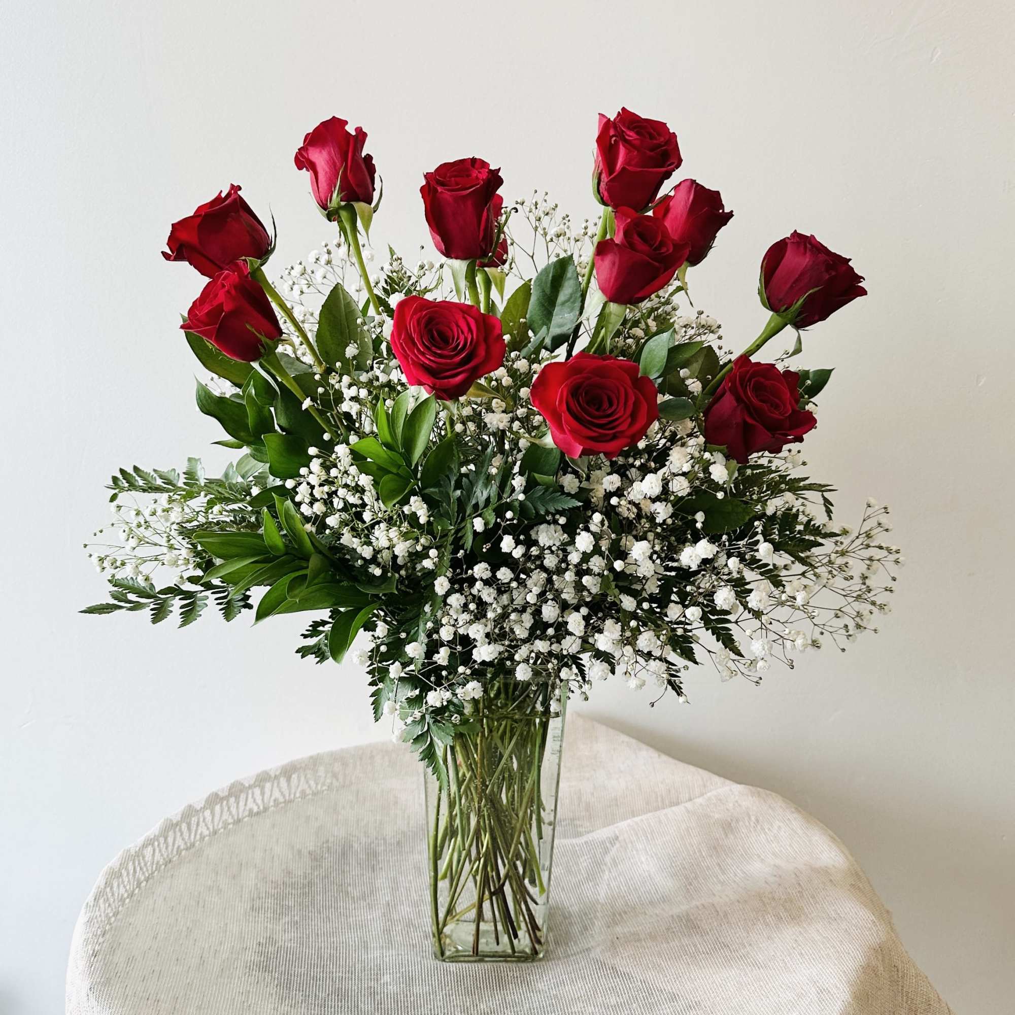 12 long stemmed red roses beautifully arranged with baby's breath. 
One of, photo 2 of 2