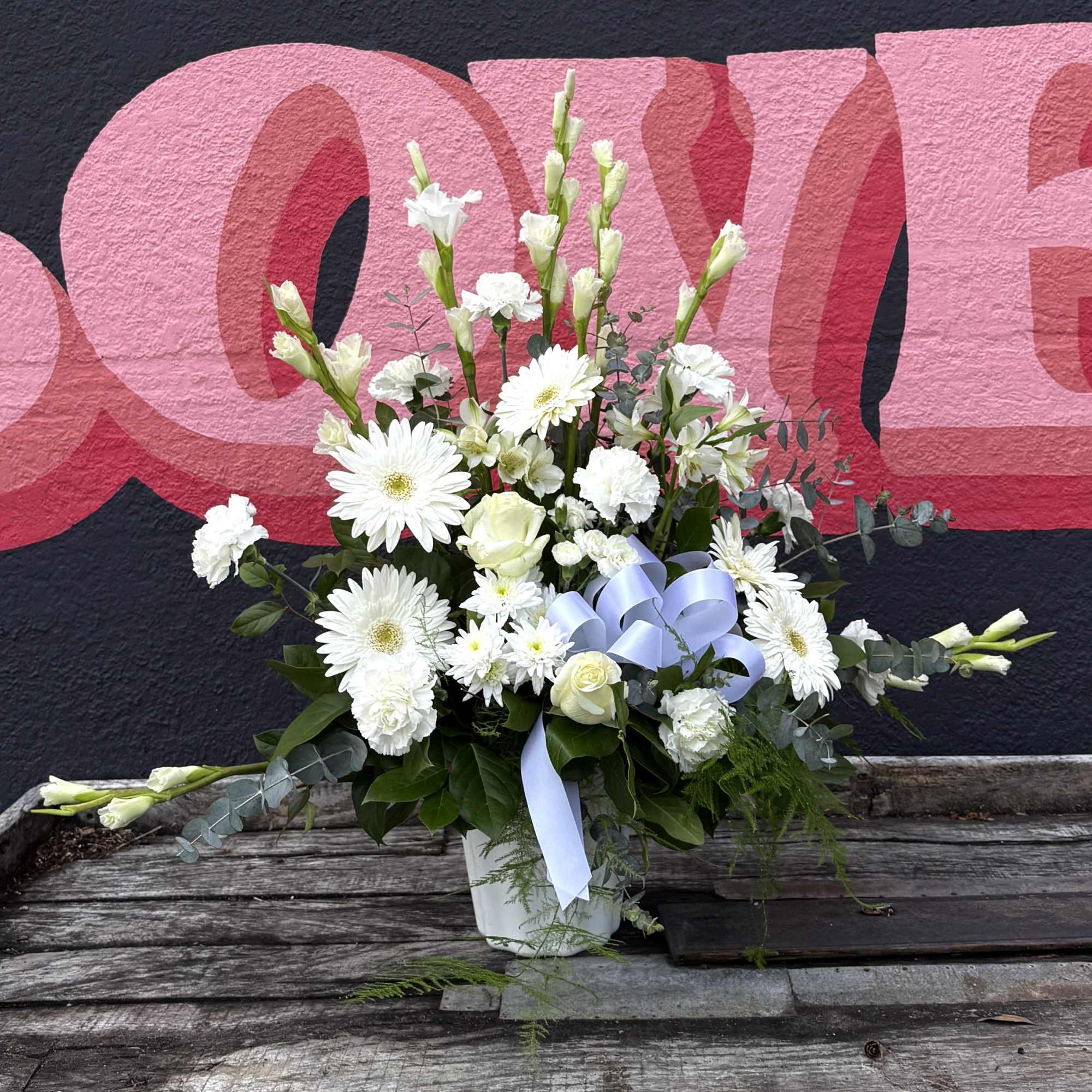 A serene fan-style sympathy flower arrangement designed to bring quiet comfort and