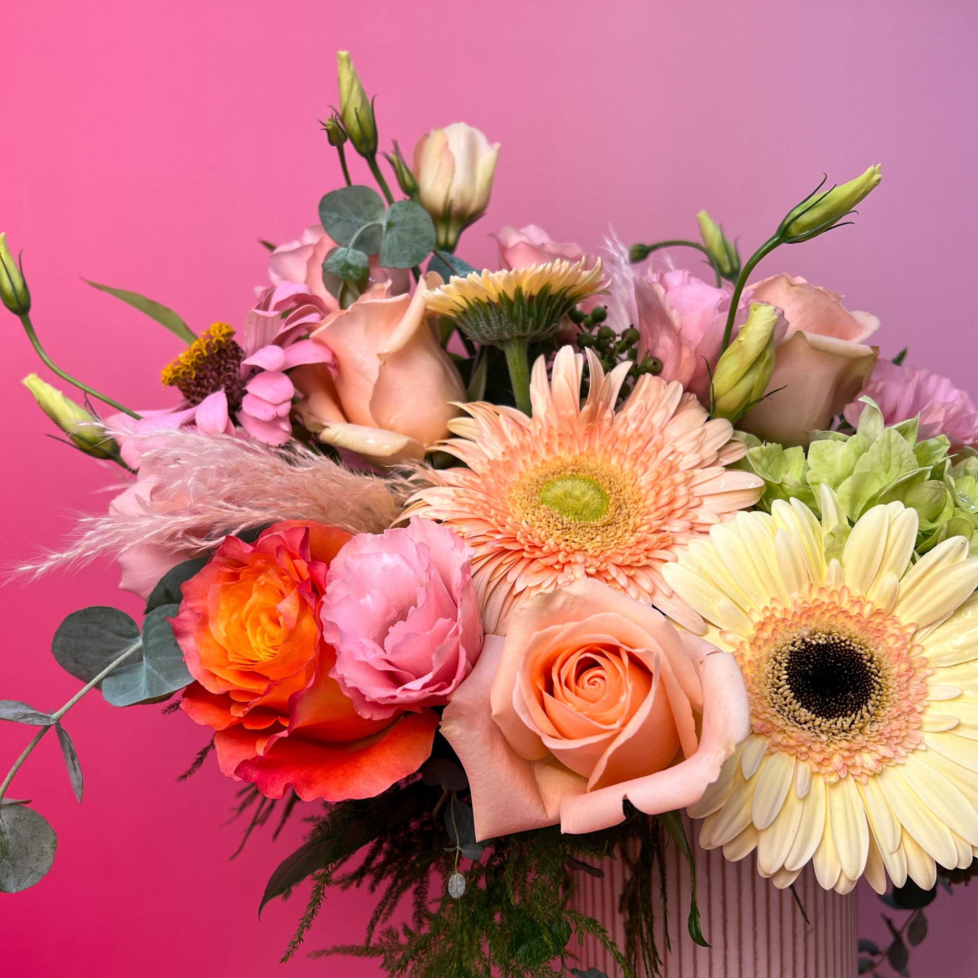 Mixed bouquet of roses, gerbera daisies, and hydrangea in a vase