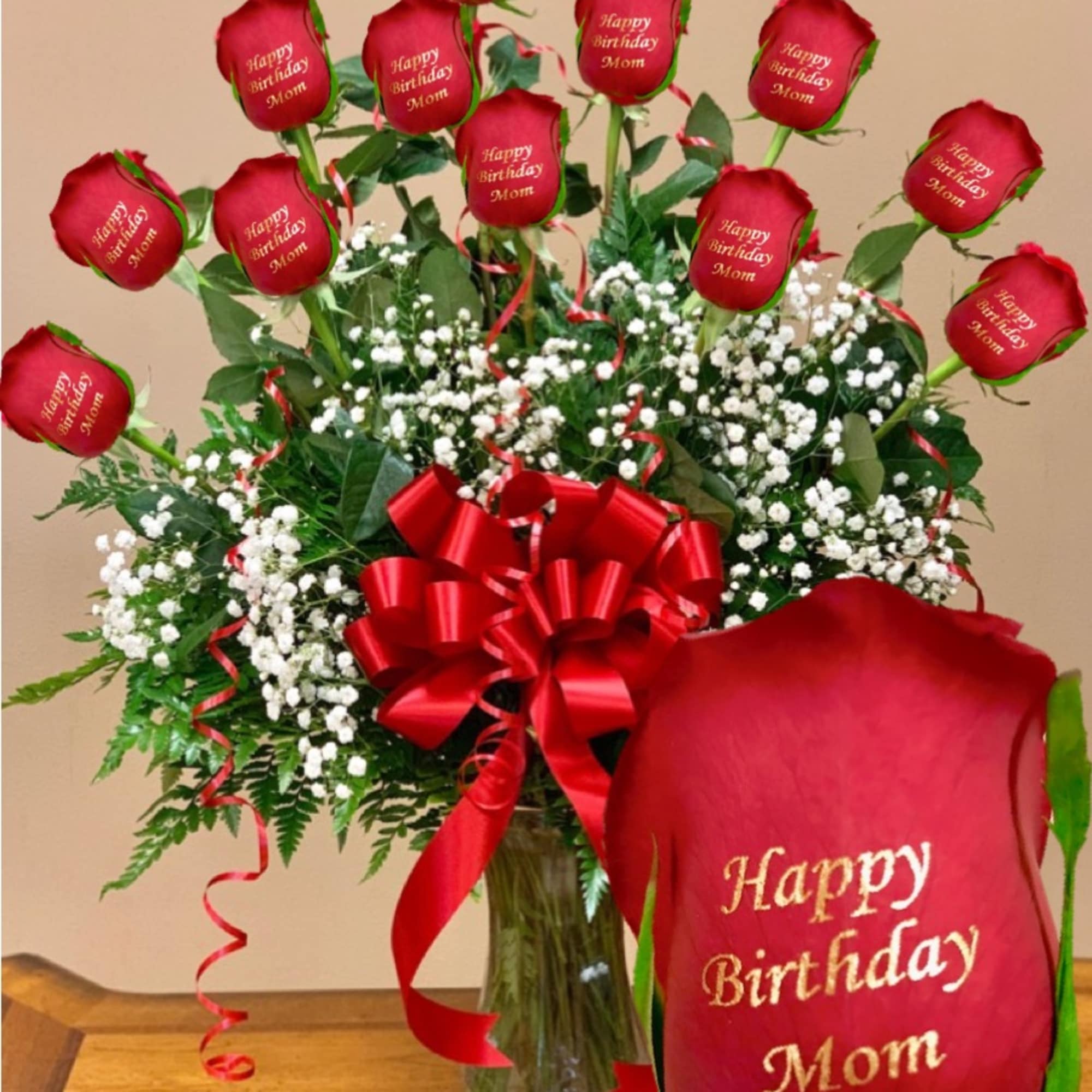 Red roses with birthday message petals in a glass vase
