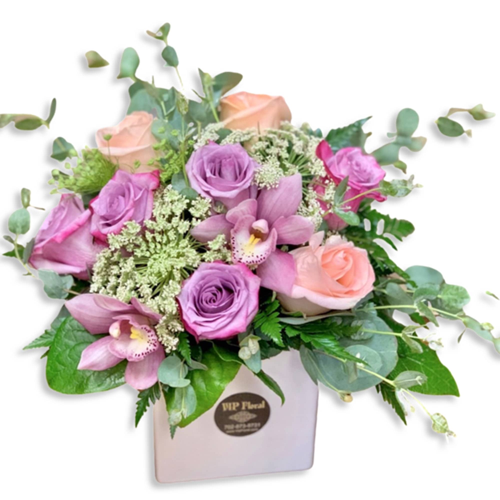 Pink and lavender roses with orchids in a white box
