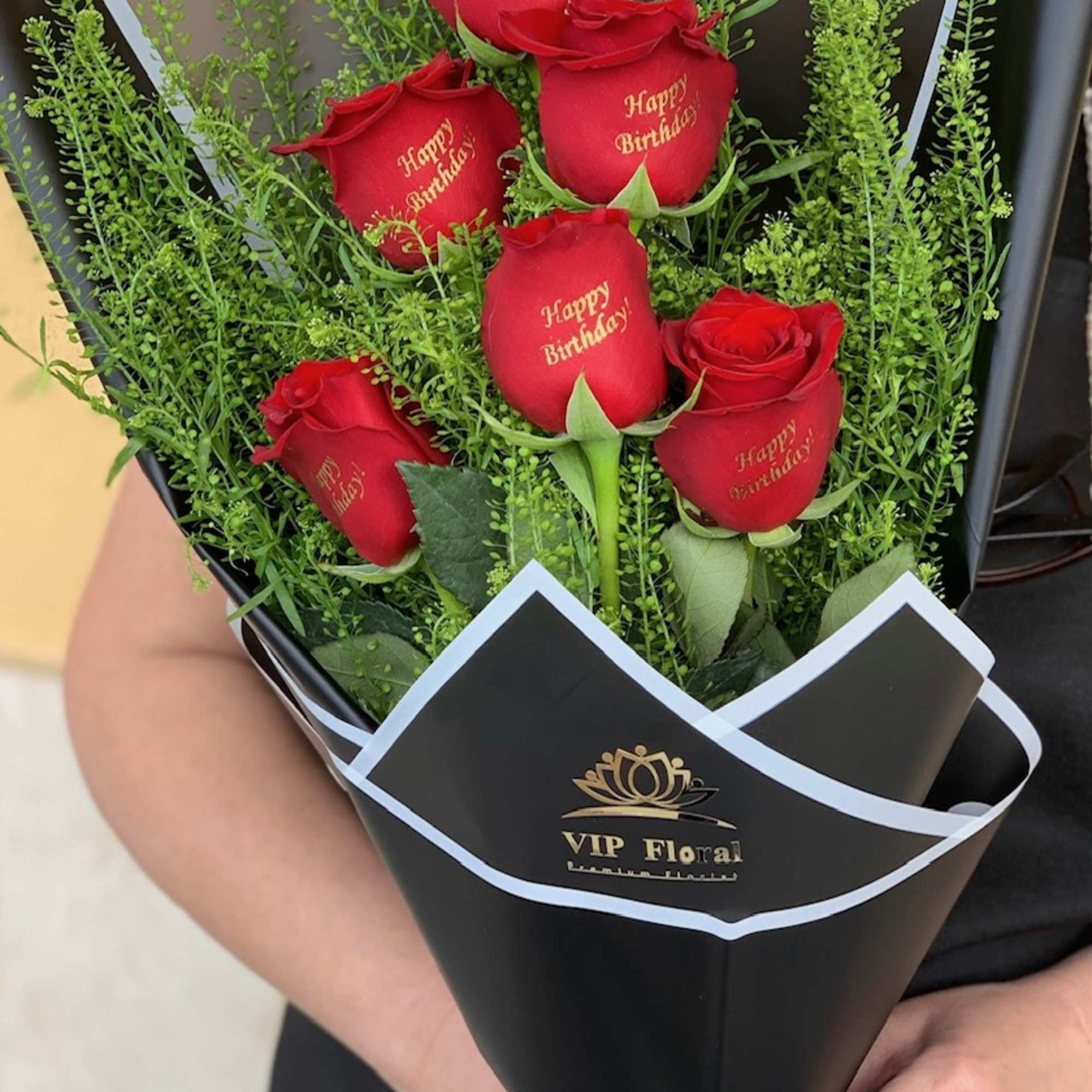 Bouquet of red roses with birthday text in black wrap