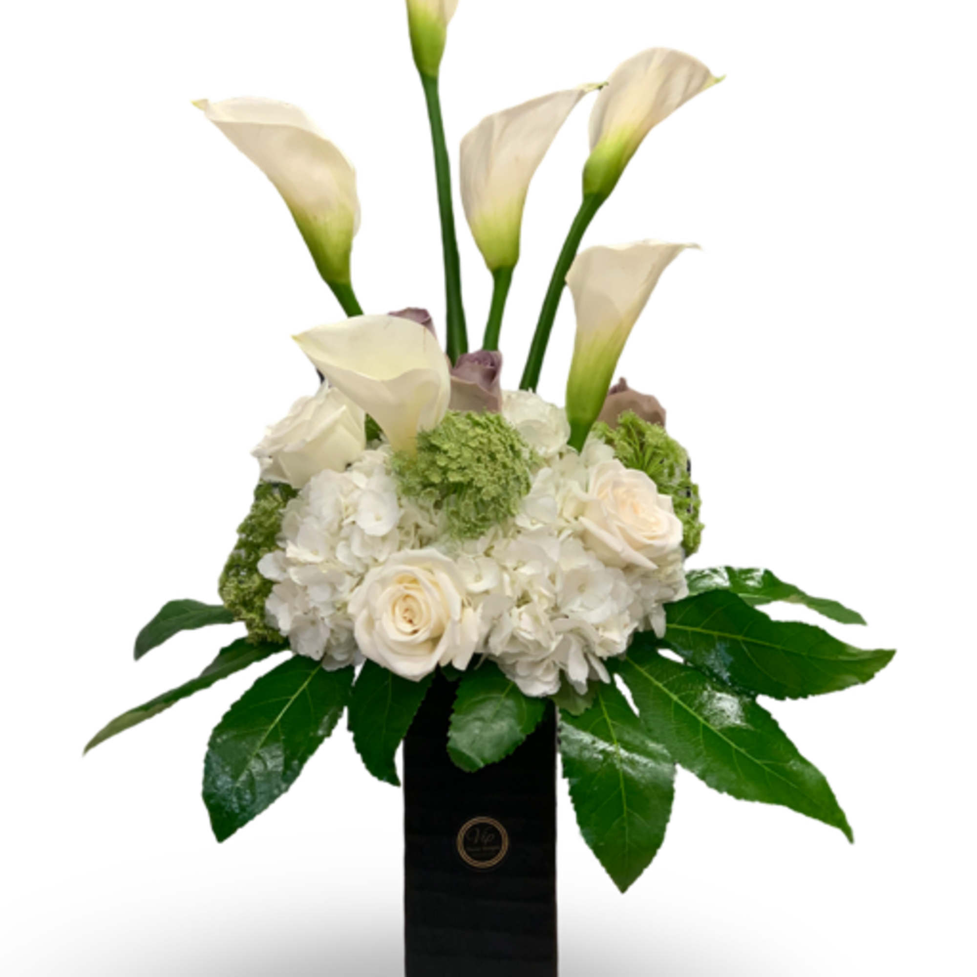 White calla lilies and roses arranged in a tall black vase
