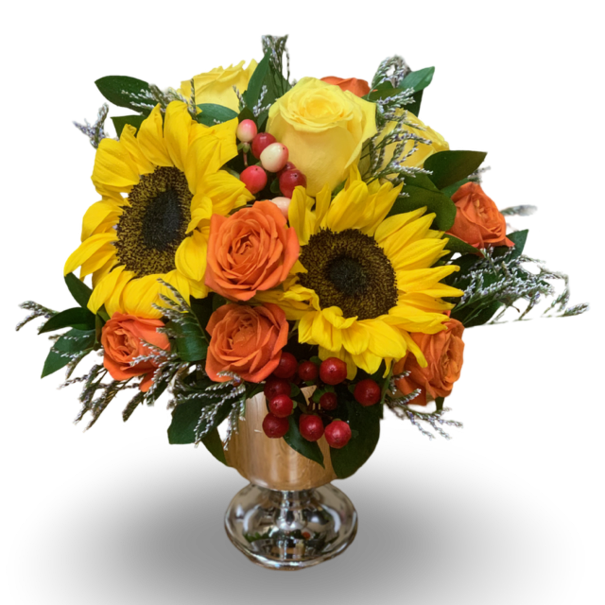Sunflowers and orange roses arranged in a glass vase