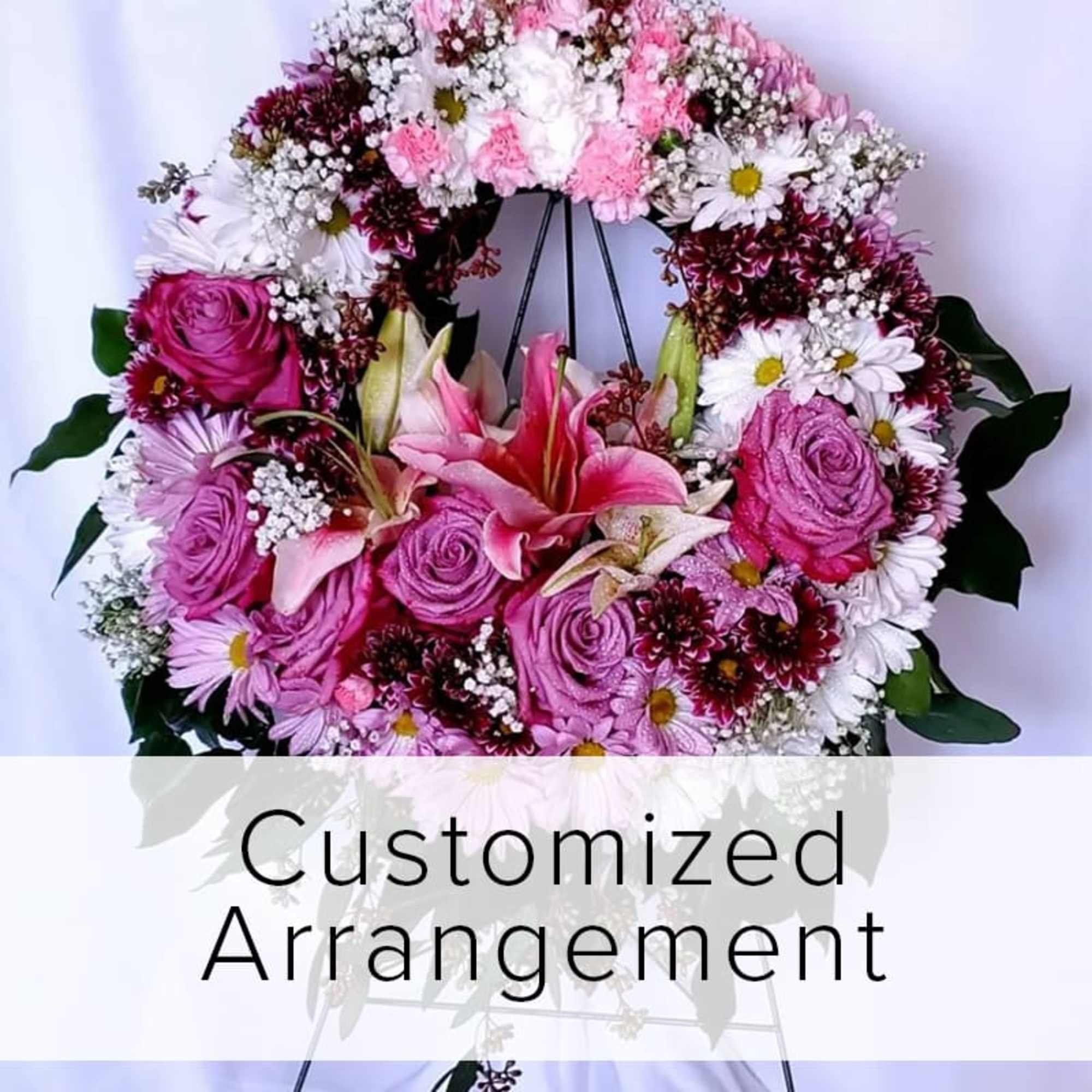 Heart-shaped floral arrangement with pink roses and lilies