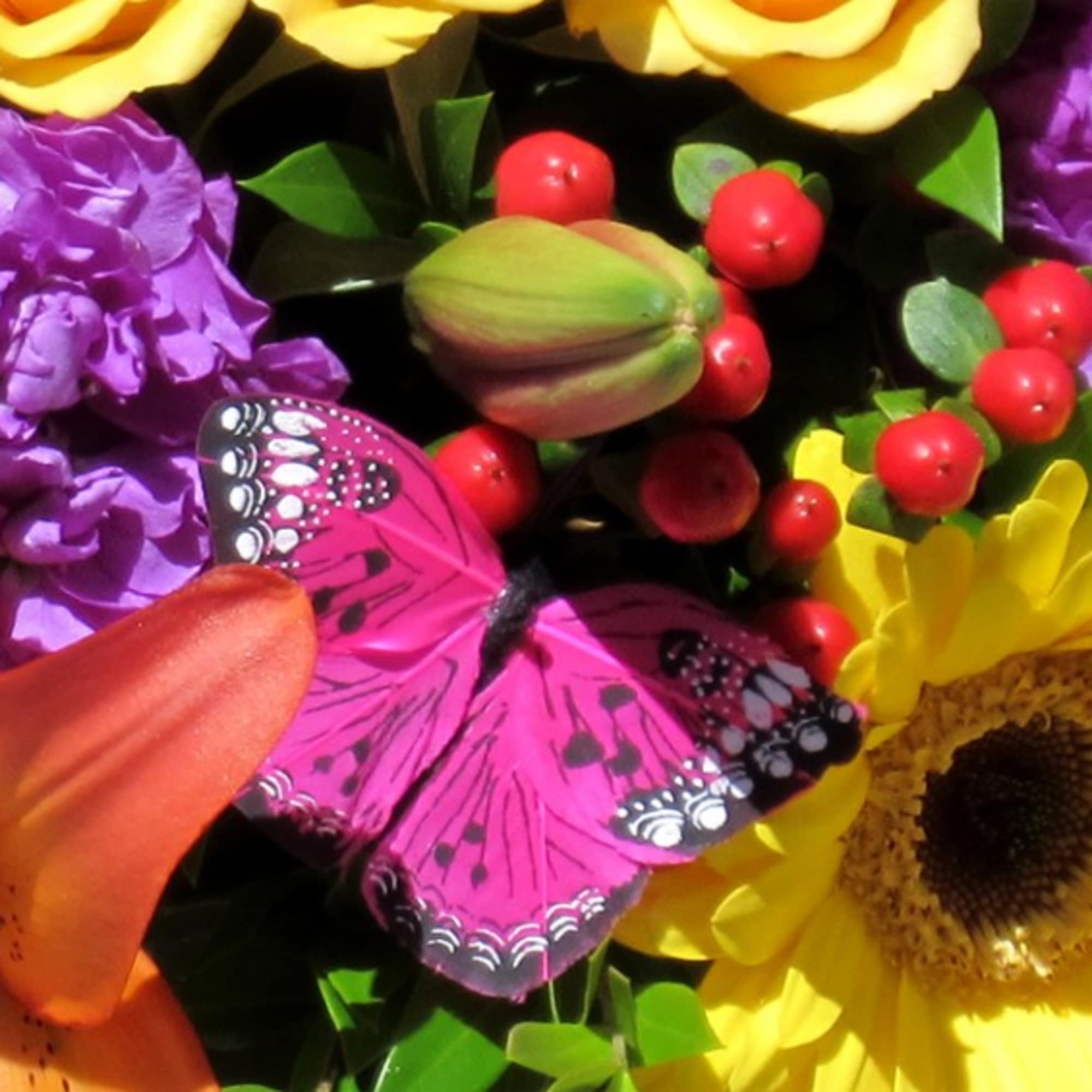 Bright mixed bouquet with a pink butterfly decoration