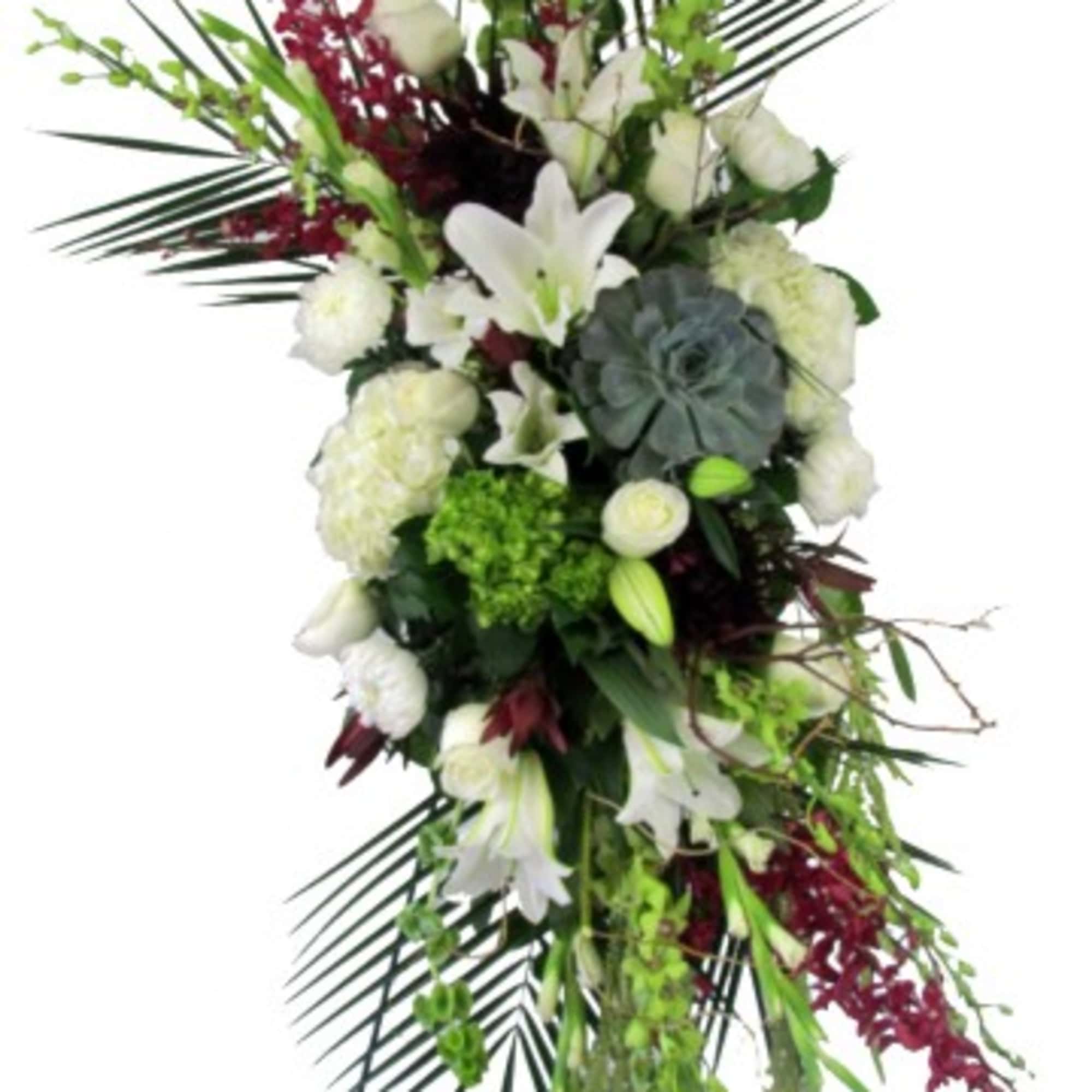 Tall white floral standing spray with lilies and roses on an easel