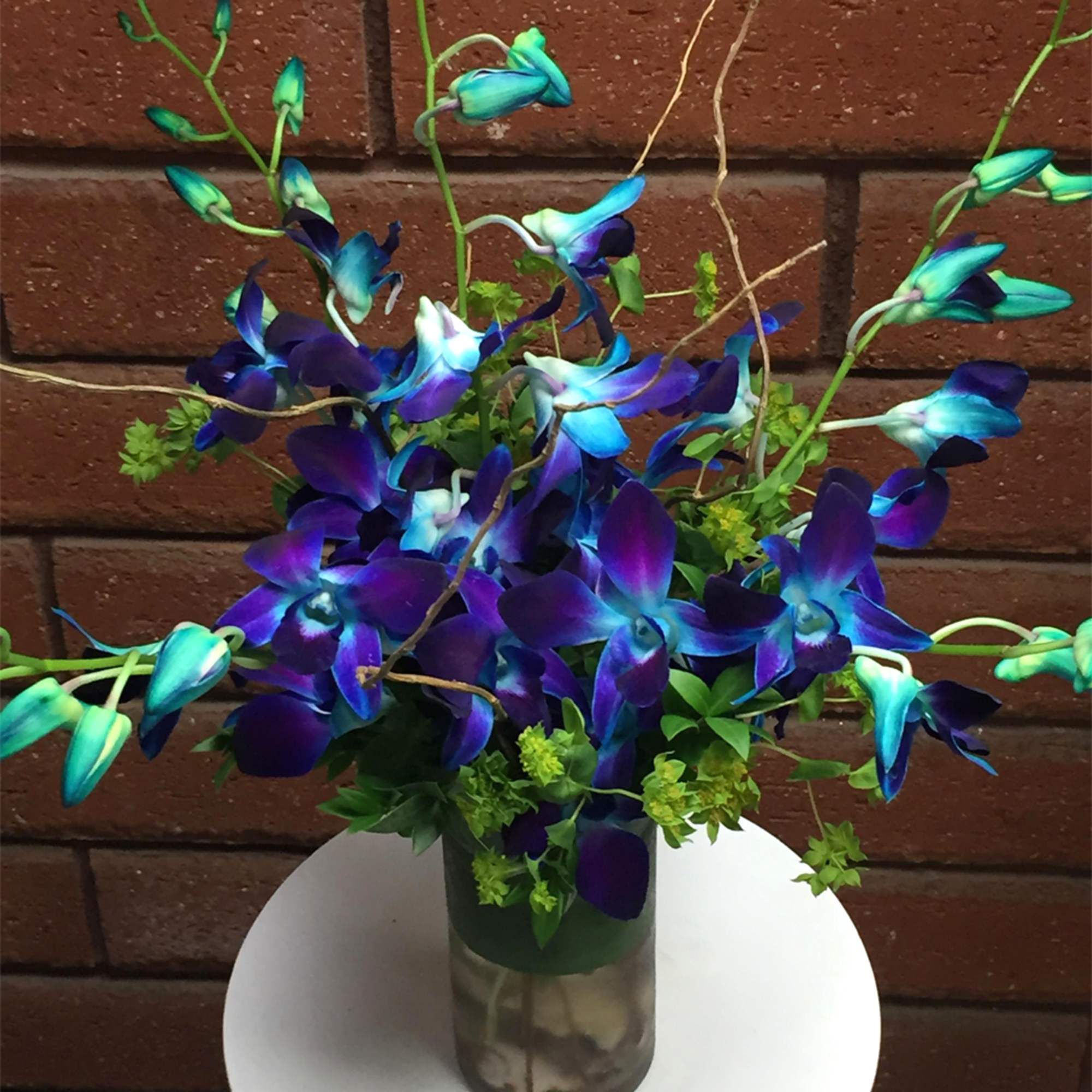 Blue and purple orchid arrangement in a glass vase, photo 2 of 2