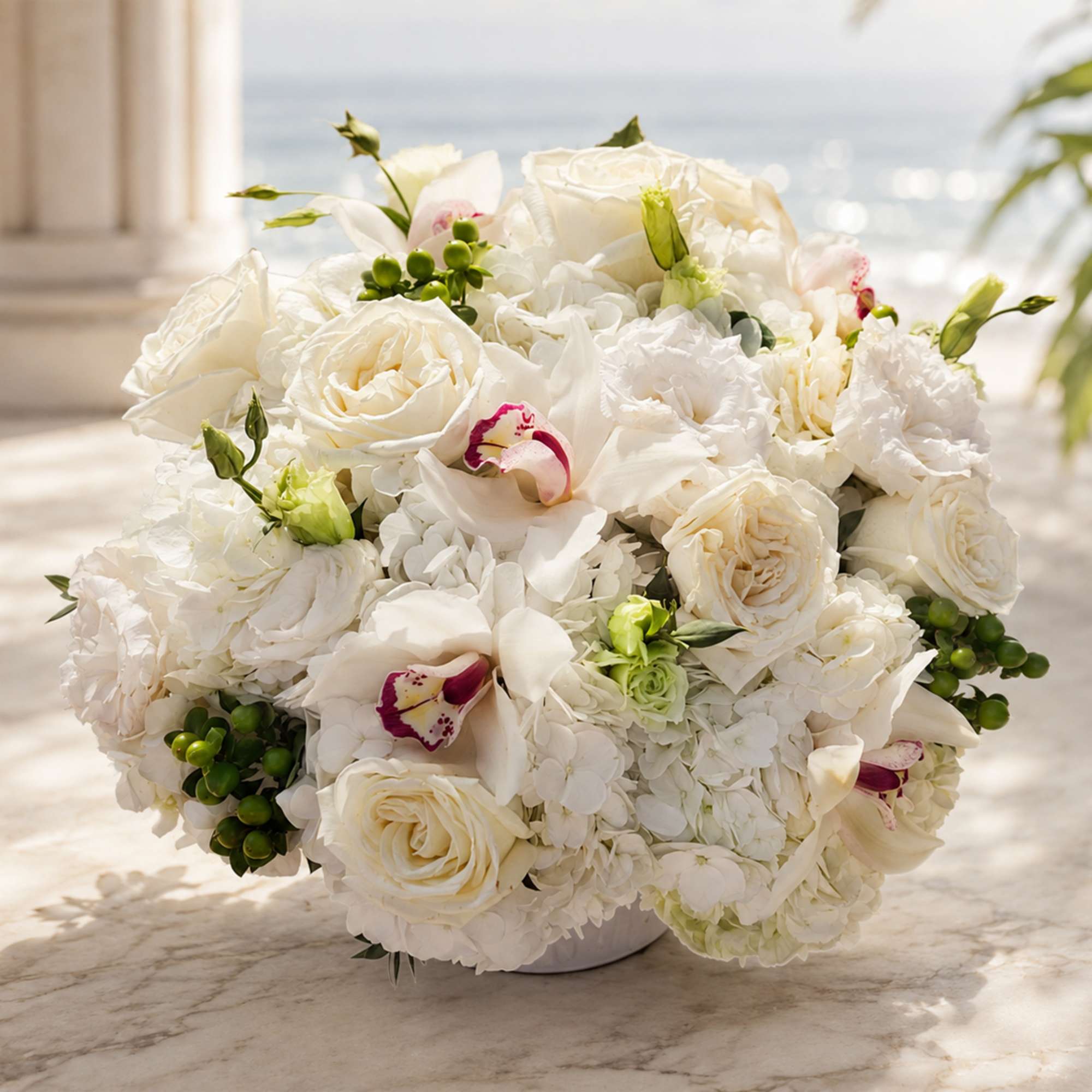 White floral bouquet with roses and orchids in a low vase