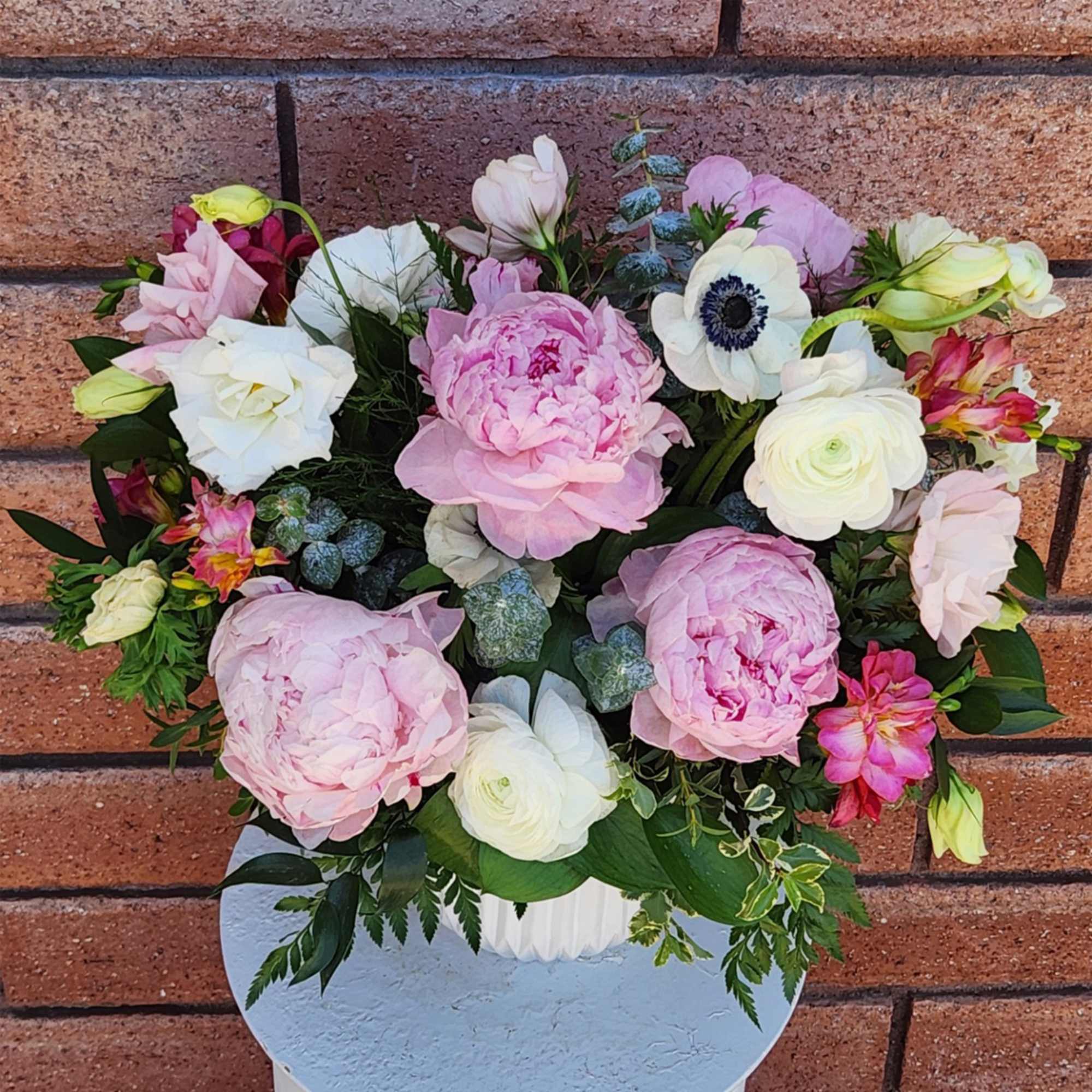Pink and white mixed flower arrangement in a white vase, photo 3 of 4