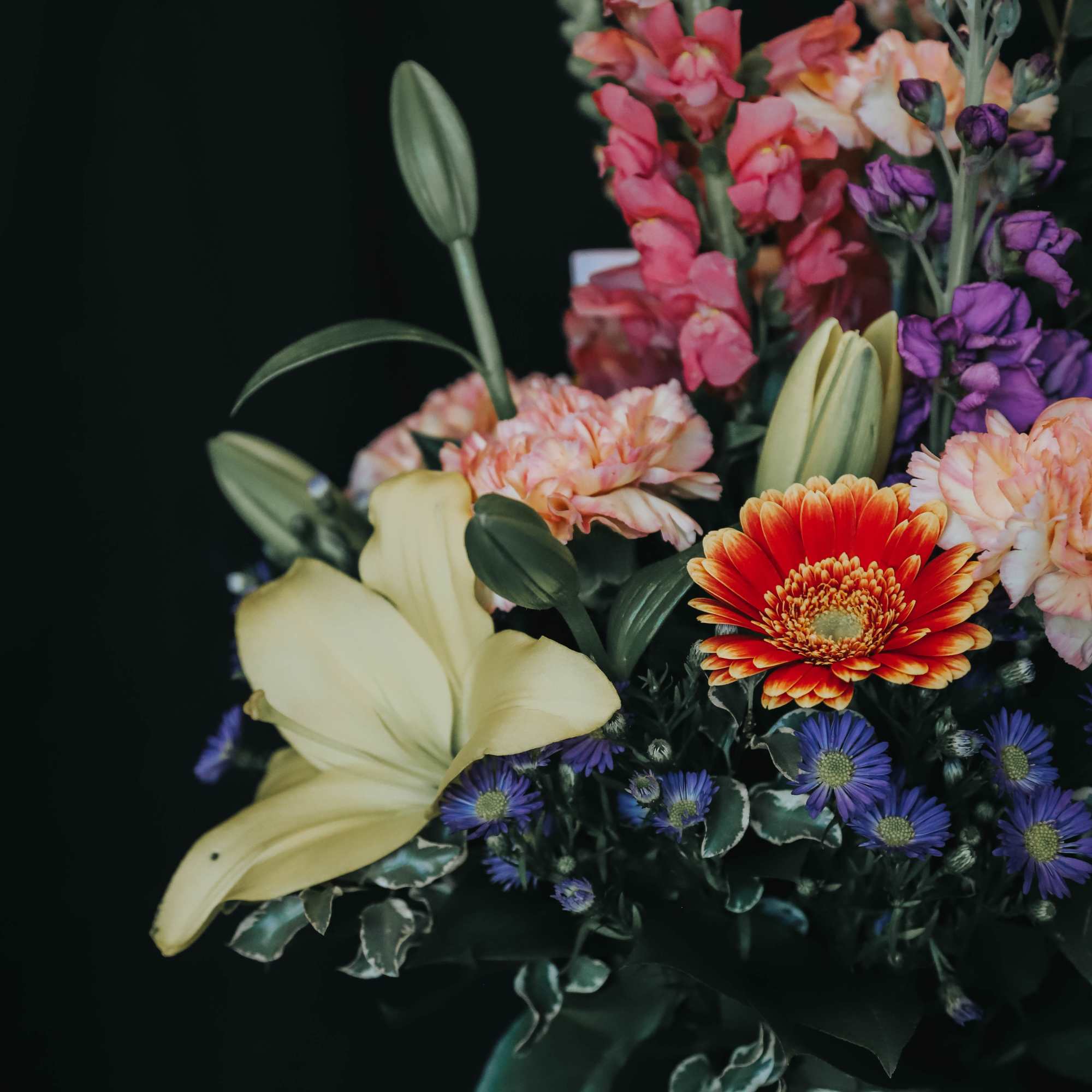 Mixed bouquet with lilies, gerbera daisies, and purple blooms