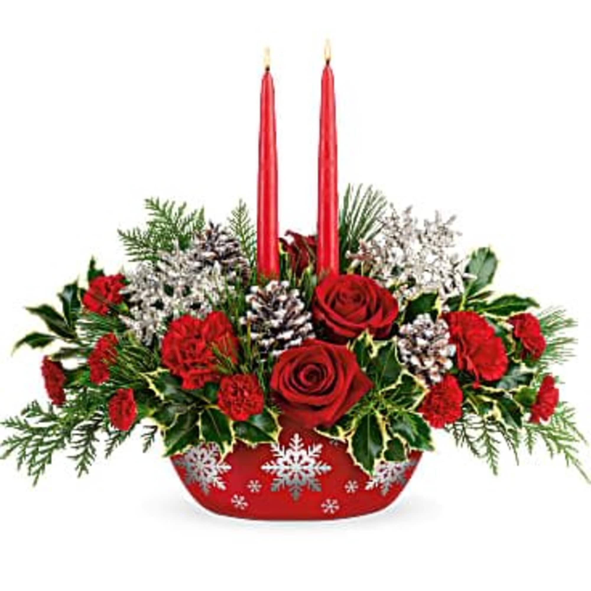 Red roses and carnations in a red holiday container with two red candles