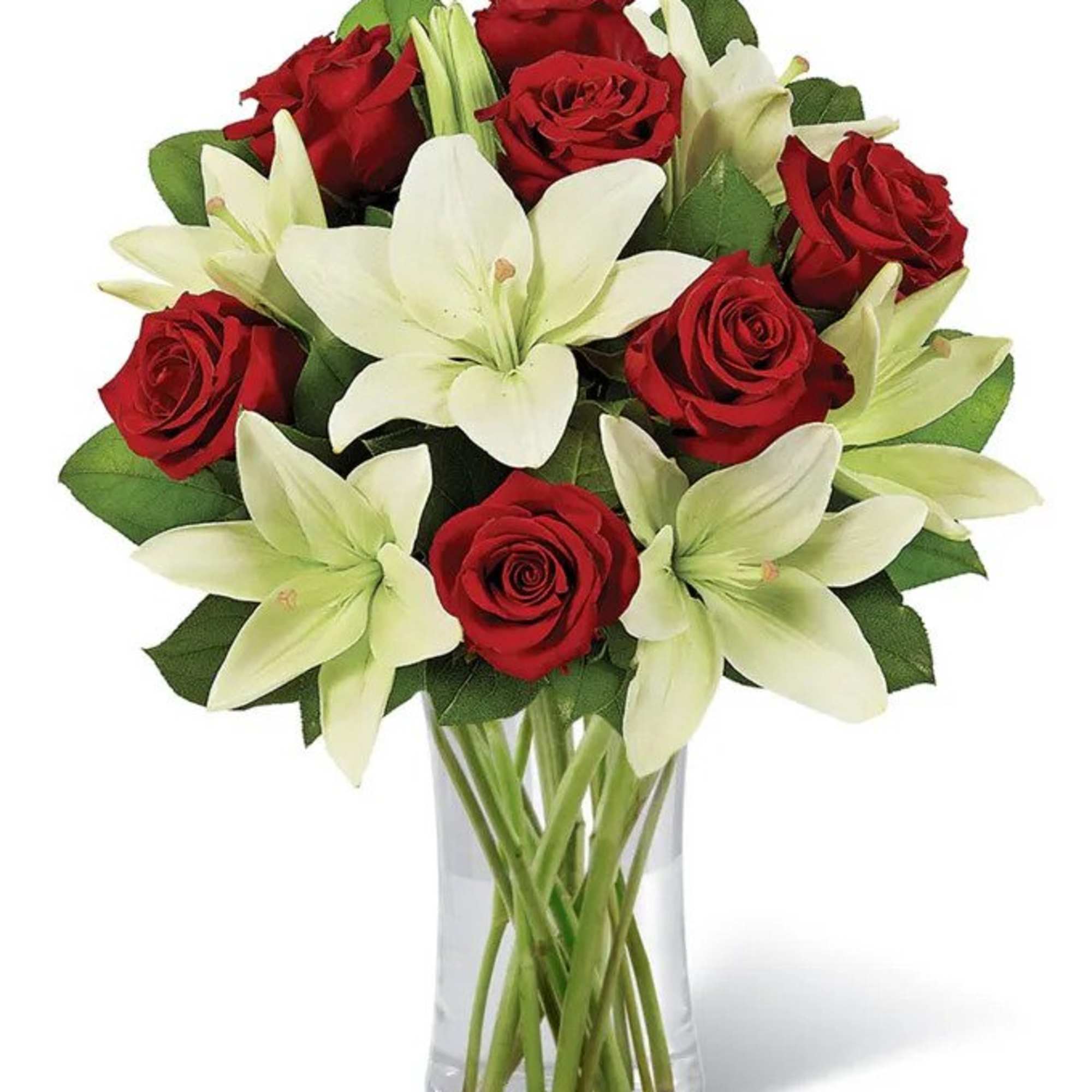Bouquet of red roses and white lilies in a clear glass vase