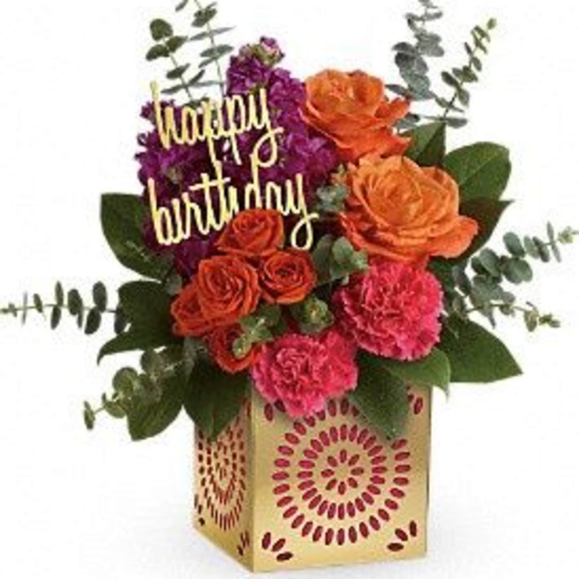 Birthday flower arrangement with roses and carnations in a patterned box