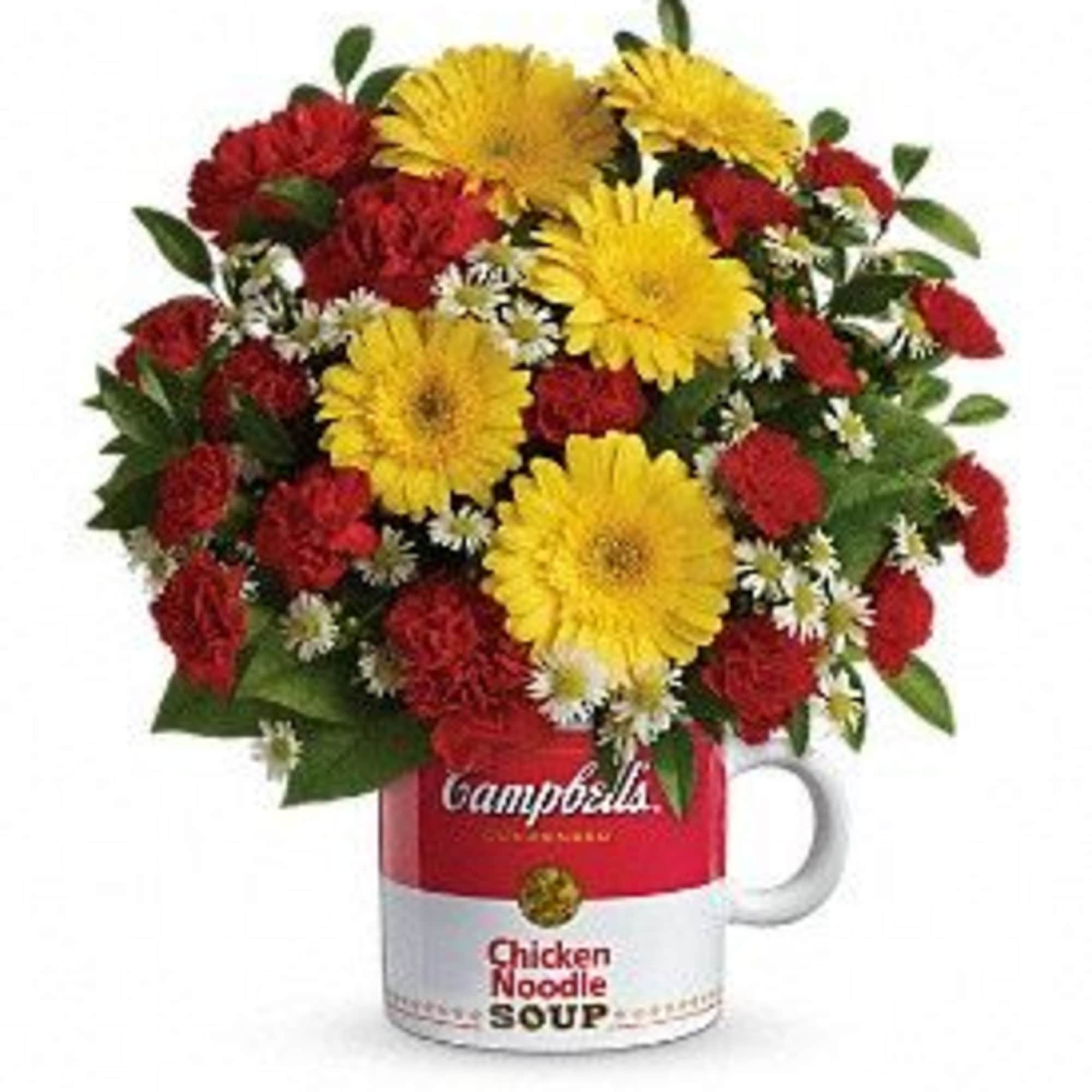 Bouquet of red and yellow flowers arranged in a soup can mug