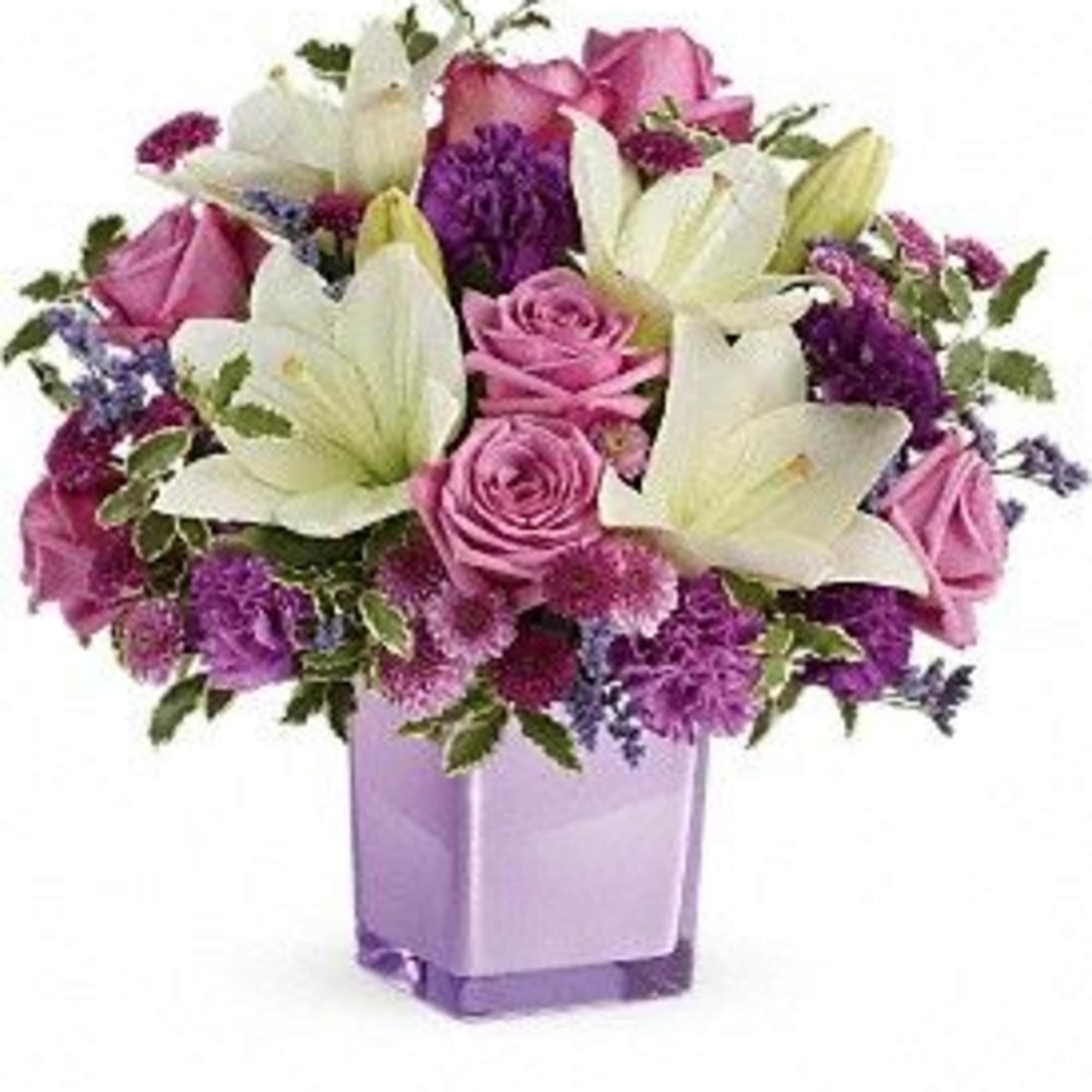 Pink roses and white lilies arranged in a lavender vase