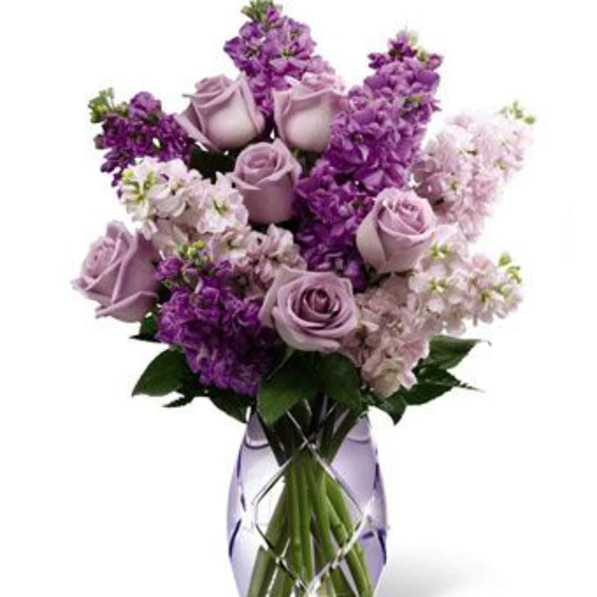 Lavender roses and purple flowers arranged in a clear vase