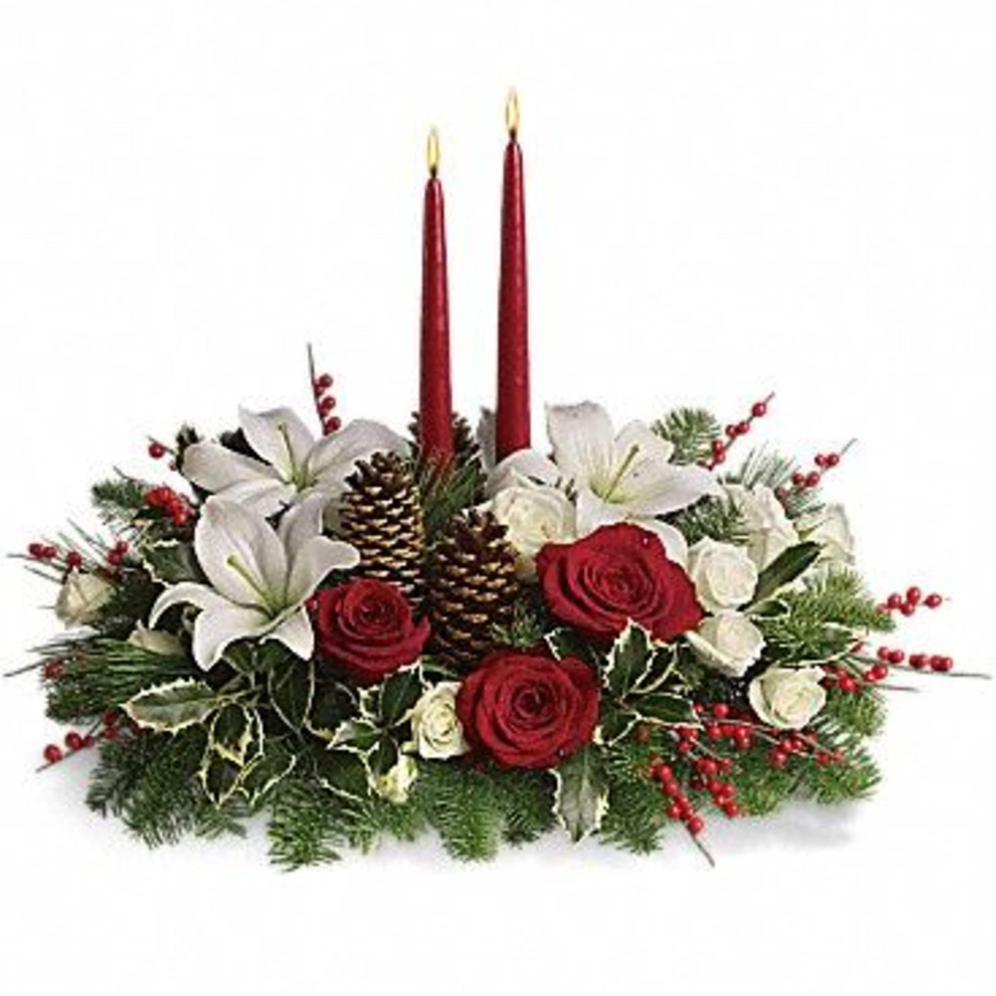 Holiday centerpiece with red candles, white lilies, and red roses