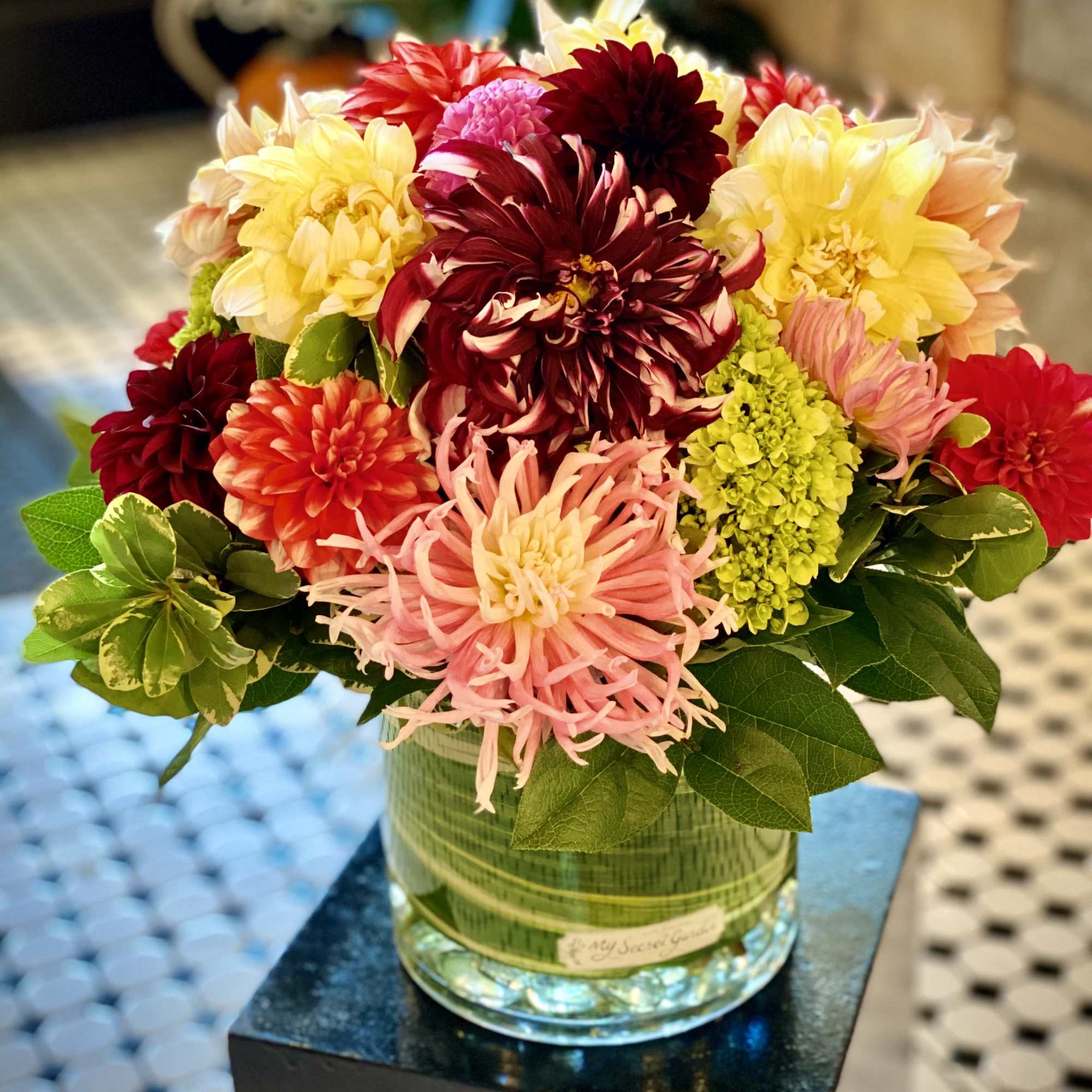 Colorful dahlia arrangement in a glass vase