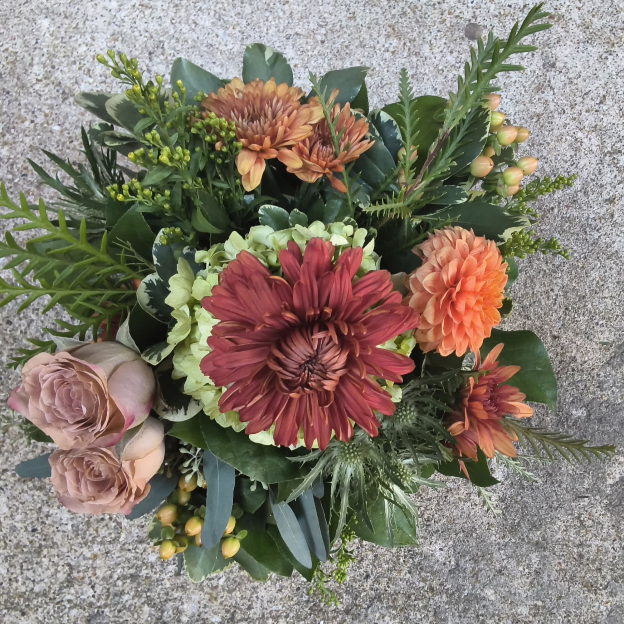 Bouquet of chrysanthemums and roses with mixed greenery