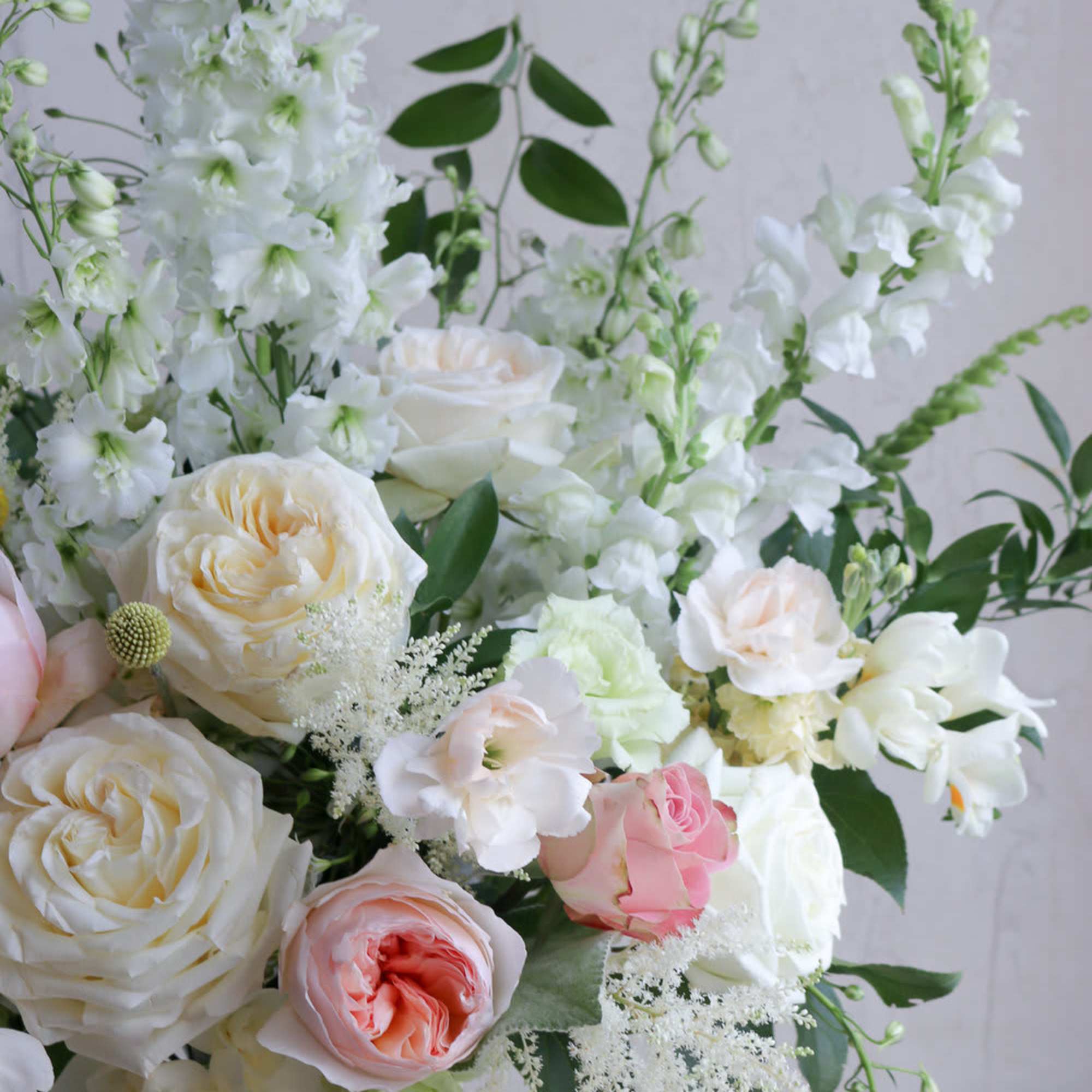 White and blush roses with tall white blooms in a glass vase, photo 3 of 3