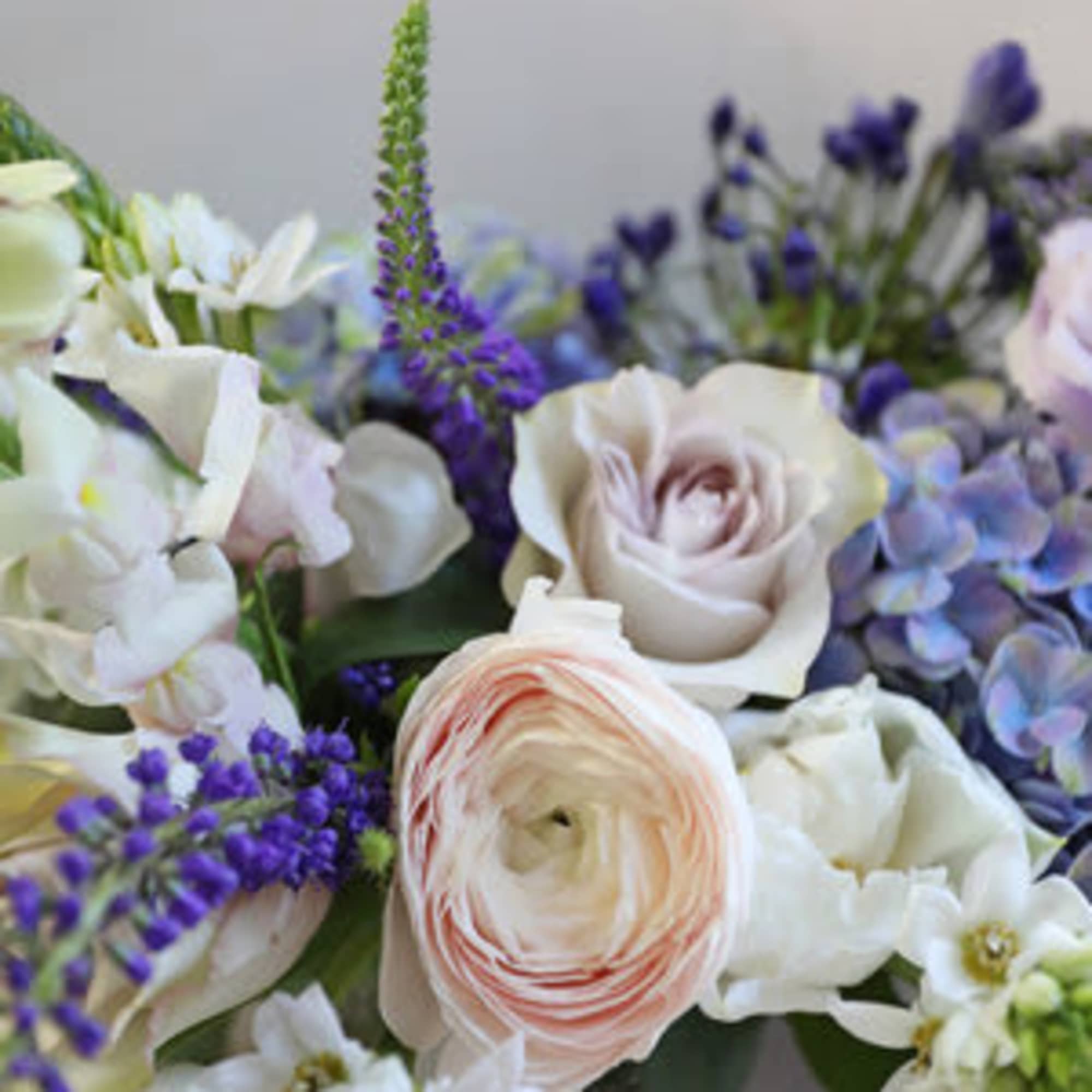 Pastel bouquet with white and blush flowers and purple accents
