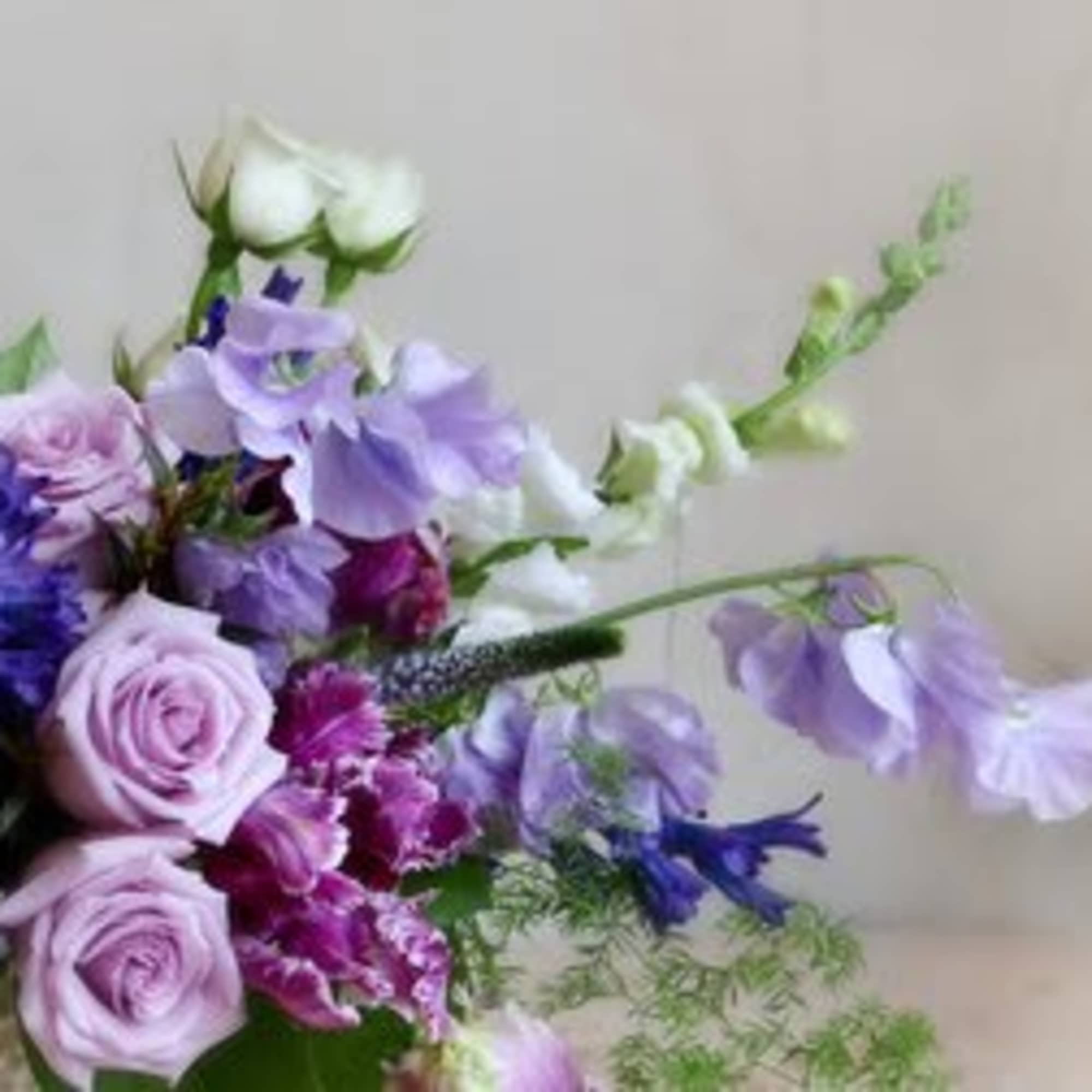 Lavender and white bouquet with roses and mixed purple flowers