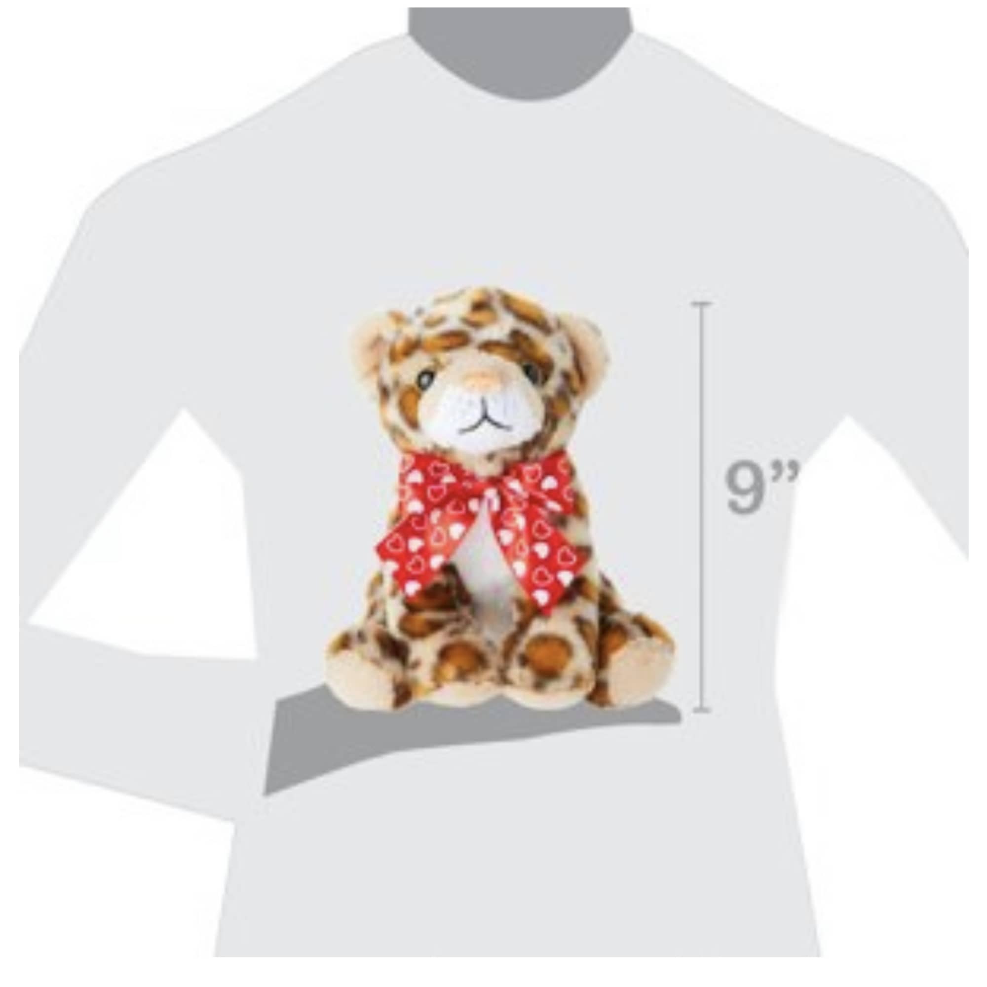 Plush leopard cub wearing a red heart-patterned bow