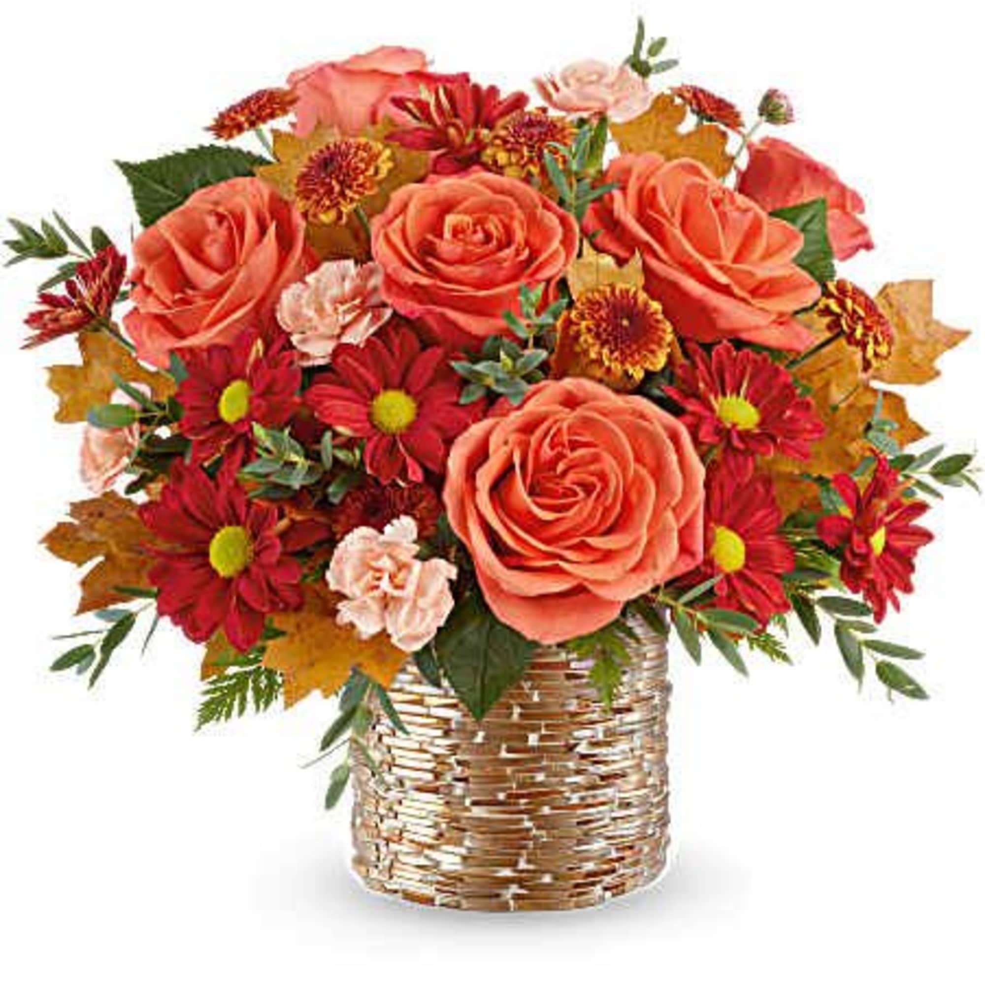 Bouquet of coral roses and red daisies in a woven basket vase