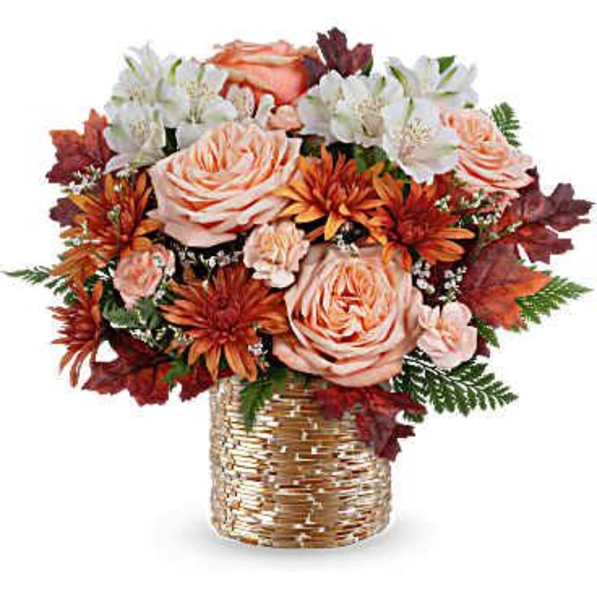 Bouquet of peach roses and white flowers in a woven vase