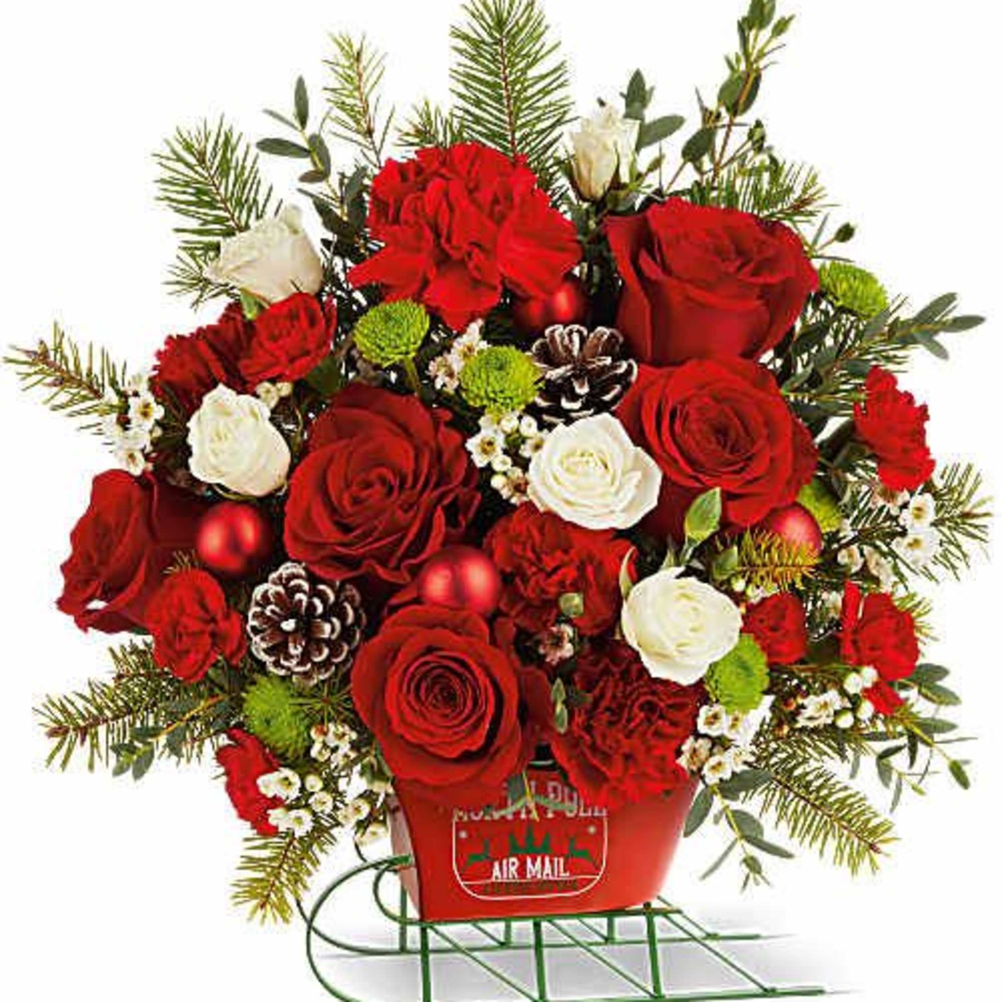 Teleflora's North Pole Sleigh Bouquet dashes in with festive color and charm!