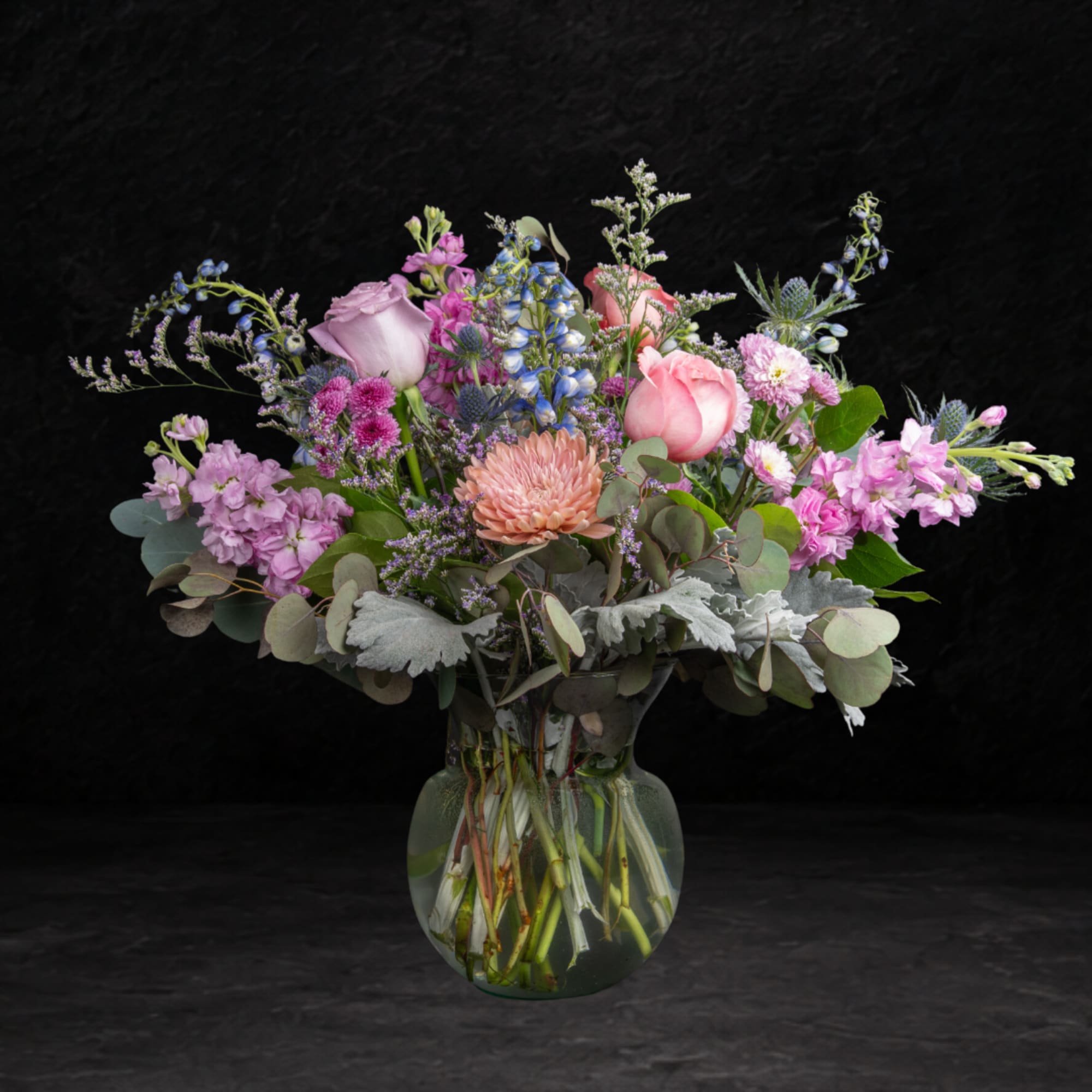 Mixed pink and lavender bouquet in a clear glass vase