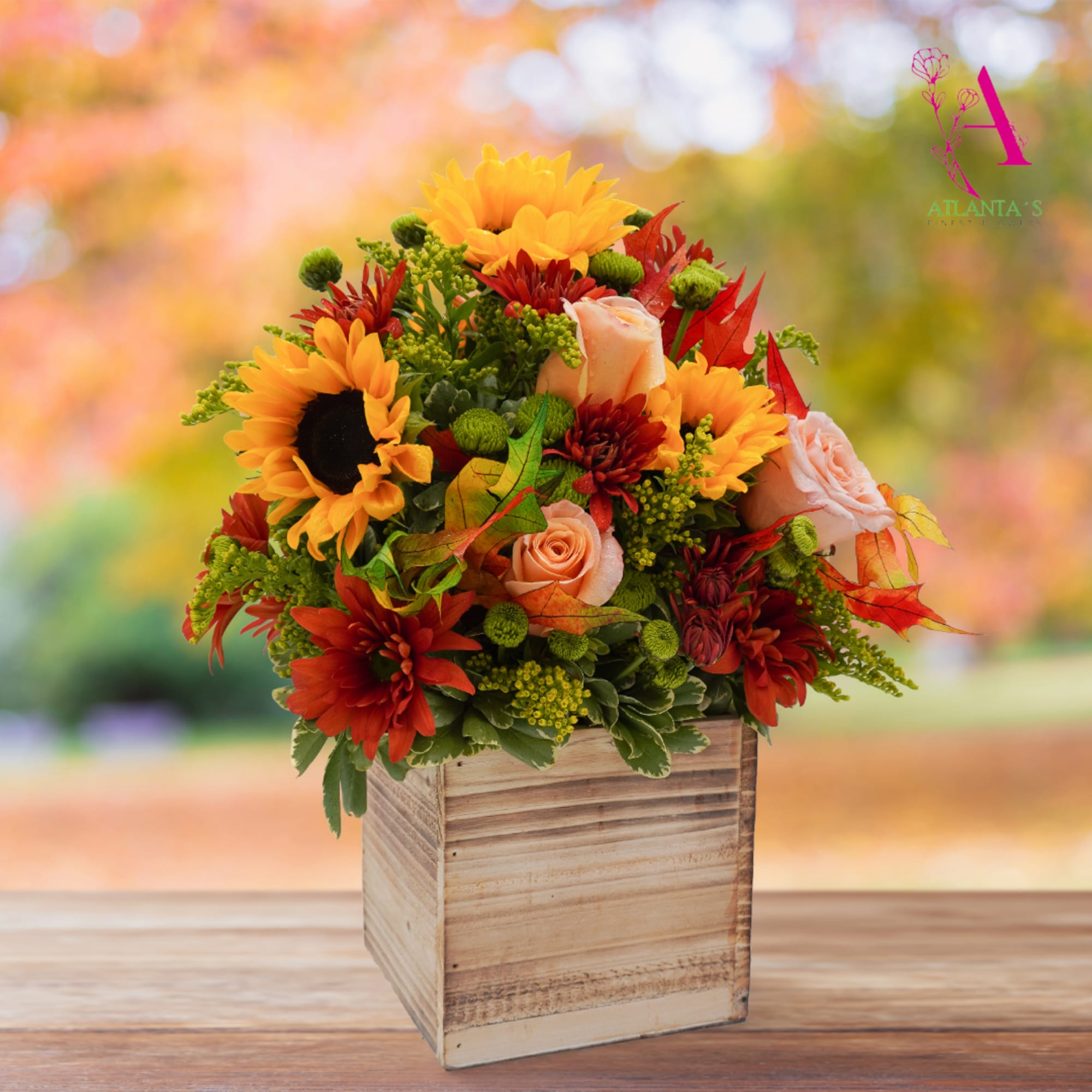 Autumn floral arrangement in a wooden box with sunflowers and roses